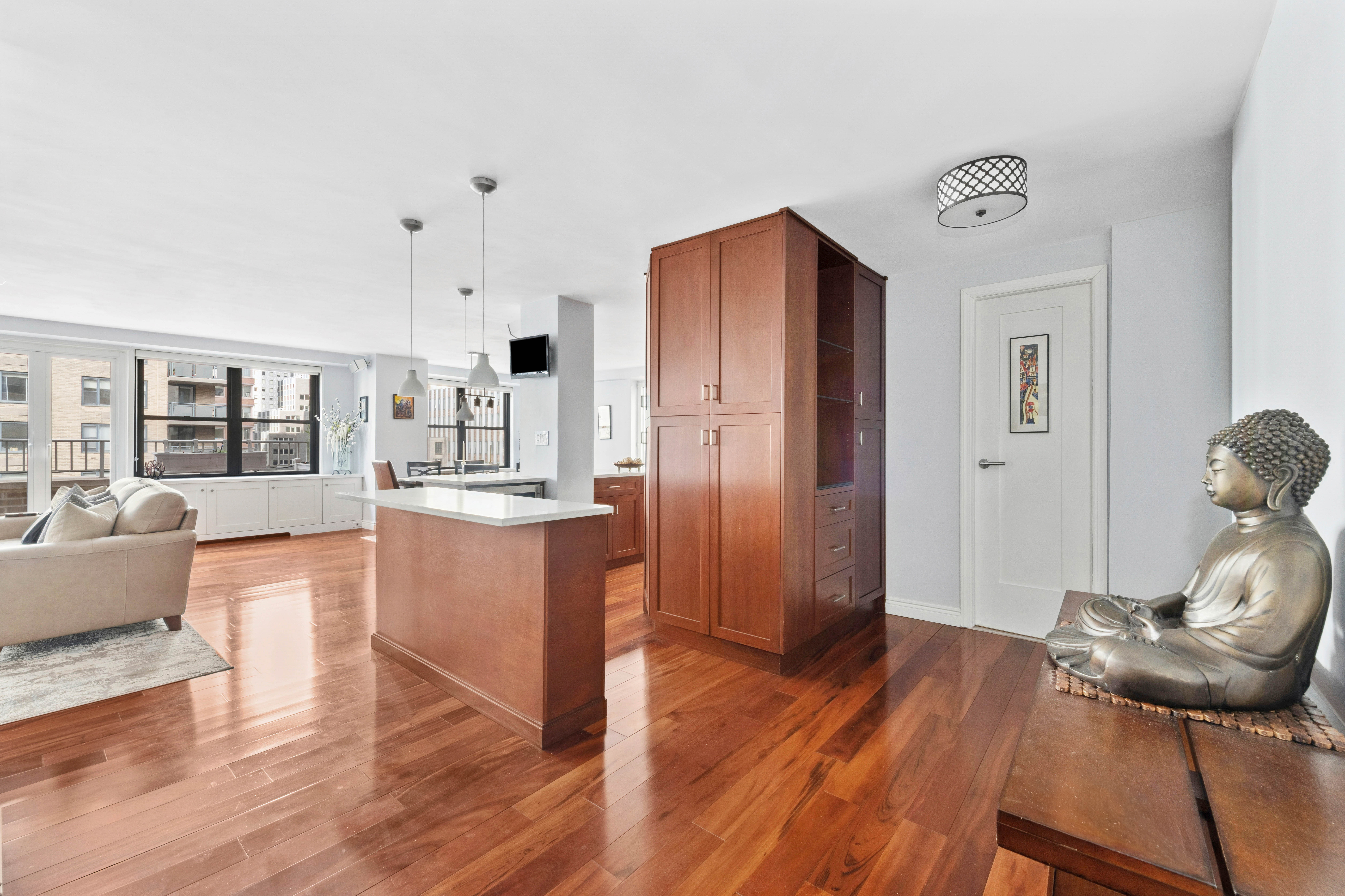 305 East 40th Street, Unit 19CD Manhattan, NY 10016 - Photo 14 of 16 a living room with stainless steel appliances furniture and a wooden floor