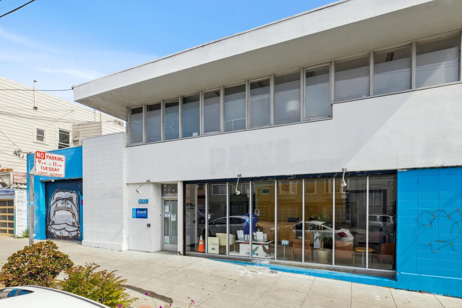 a front view of a building with a glass door and a floor to ceiling window