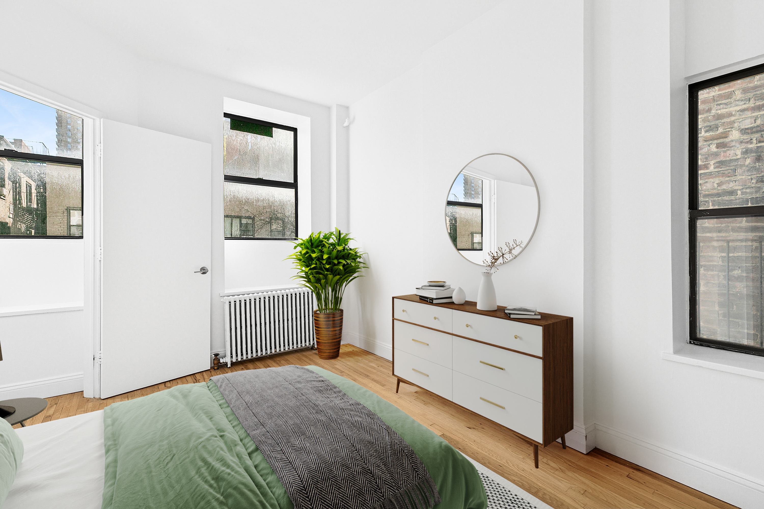 643 9th Avenue, Unit 4A Manhattan, NY 10036 - Photo 3 of 5 a bedroom with a bed and a potted plant