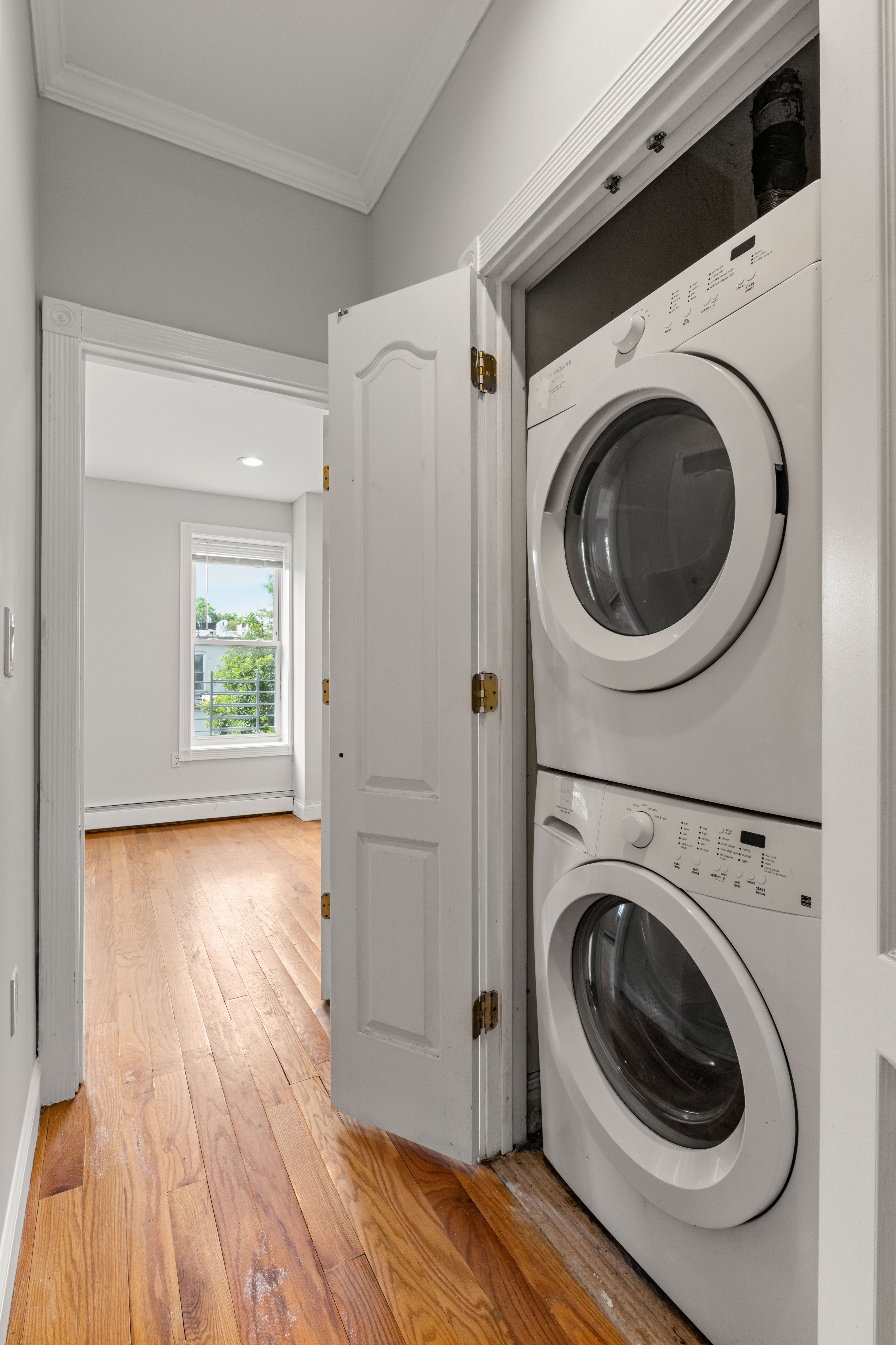 397 Bainbridge Street Brooklyn, NY 11233 - Photo 10 of 12 a view of a hallway with washer and dryer