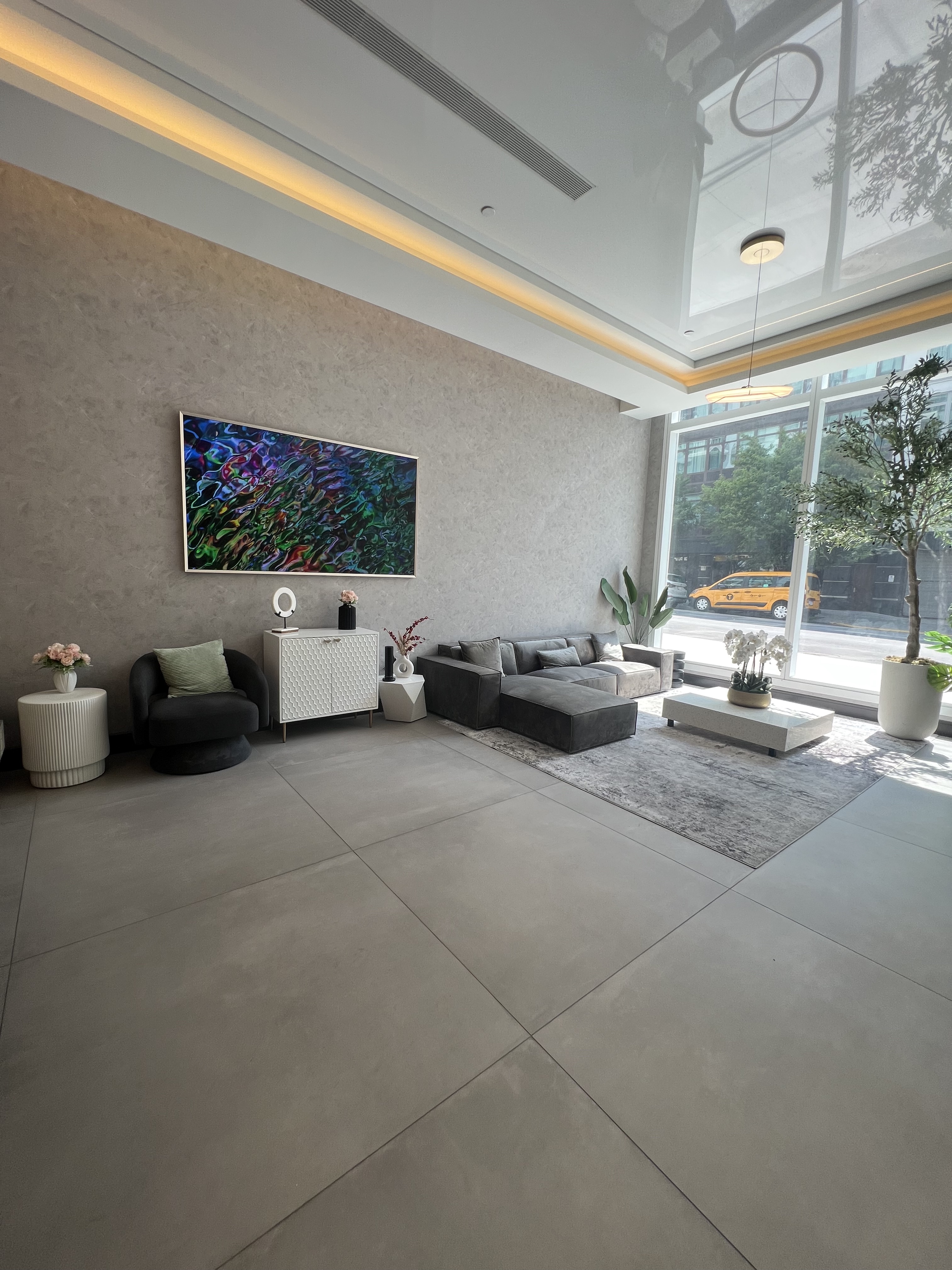 37-34 33rd Street, Unit 7H Queens, NY 11101 - Photo 17 of 18 a living room with furniture and a flat screen tv