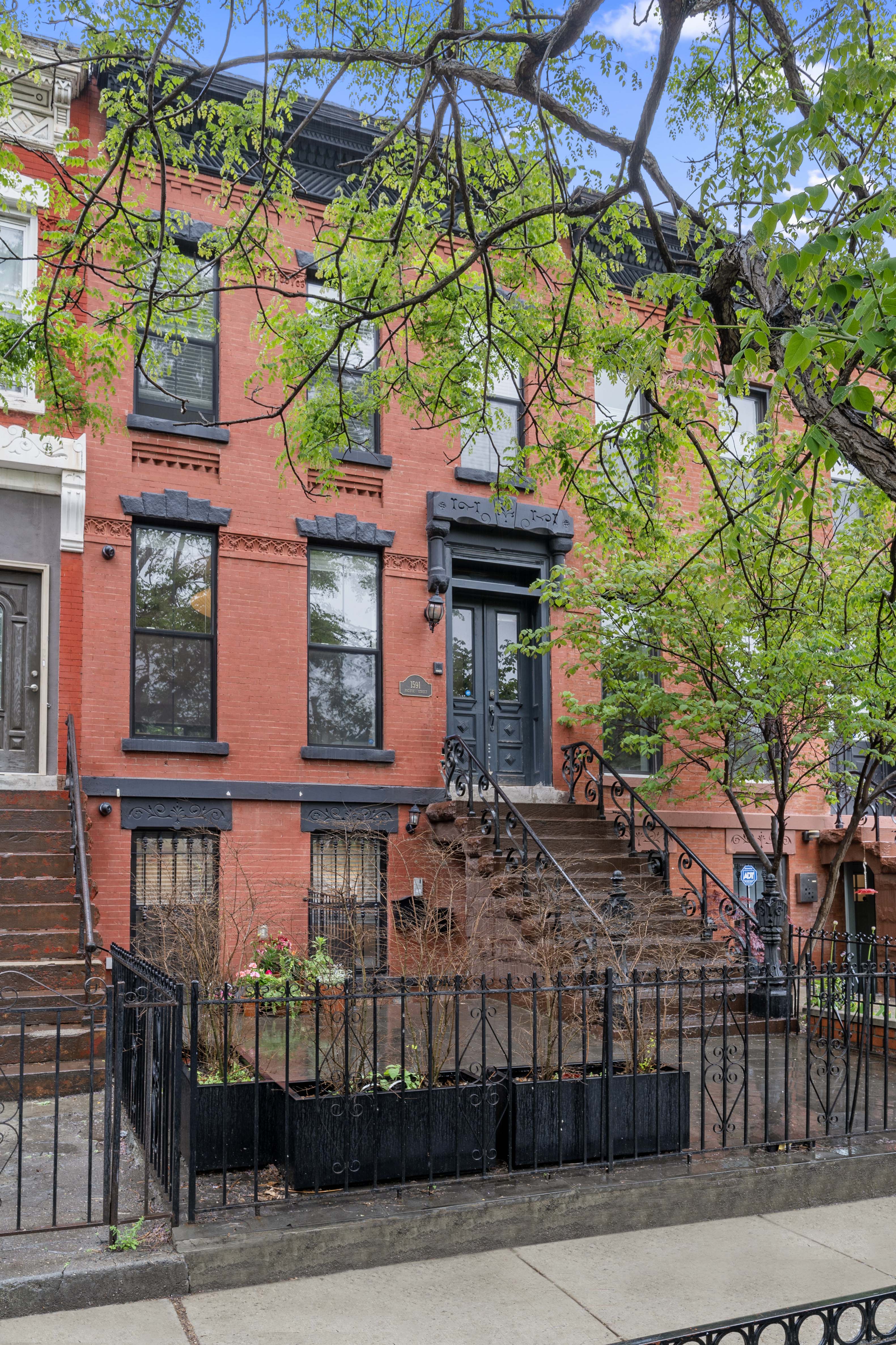 1591 Pacific Street Brooklyn, NY 11213 - Photo 15 of 16 a view of a house with a small yard and wooden fence