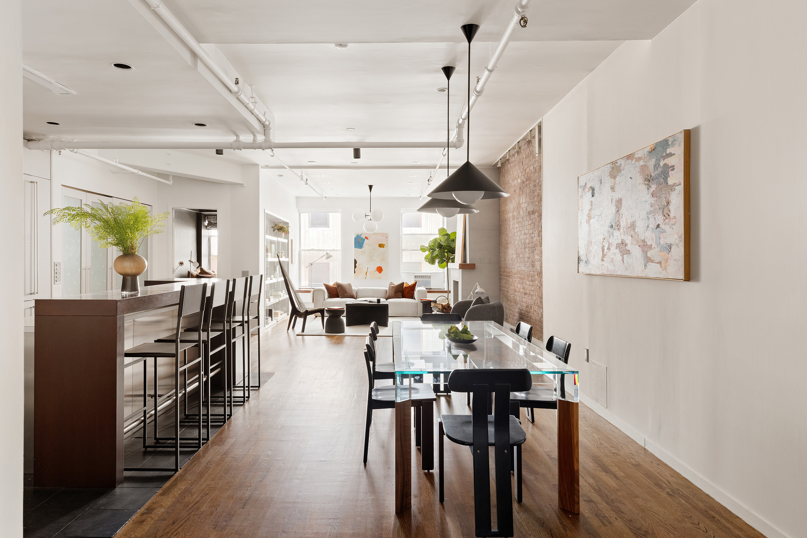 214 West 17th Street, Unit 4B Manhattan, NY 10011 - Photo 2 of 10 a view of a dining room and livingroom with furniture wooden floor a rug a painting and a chandelier