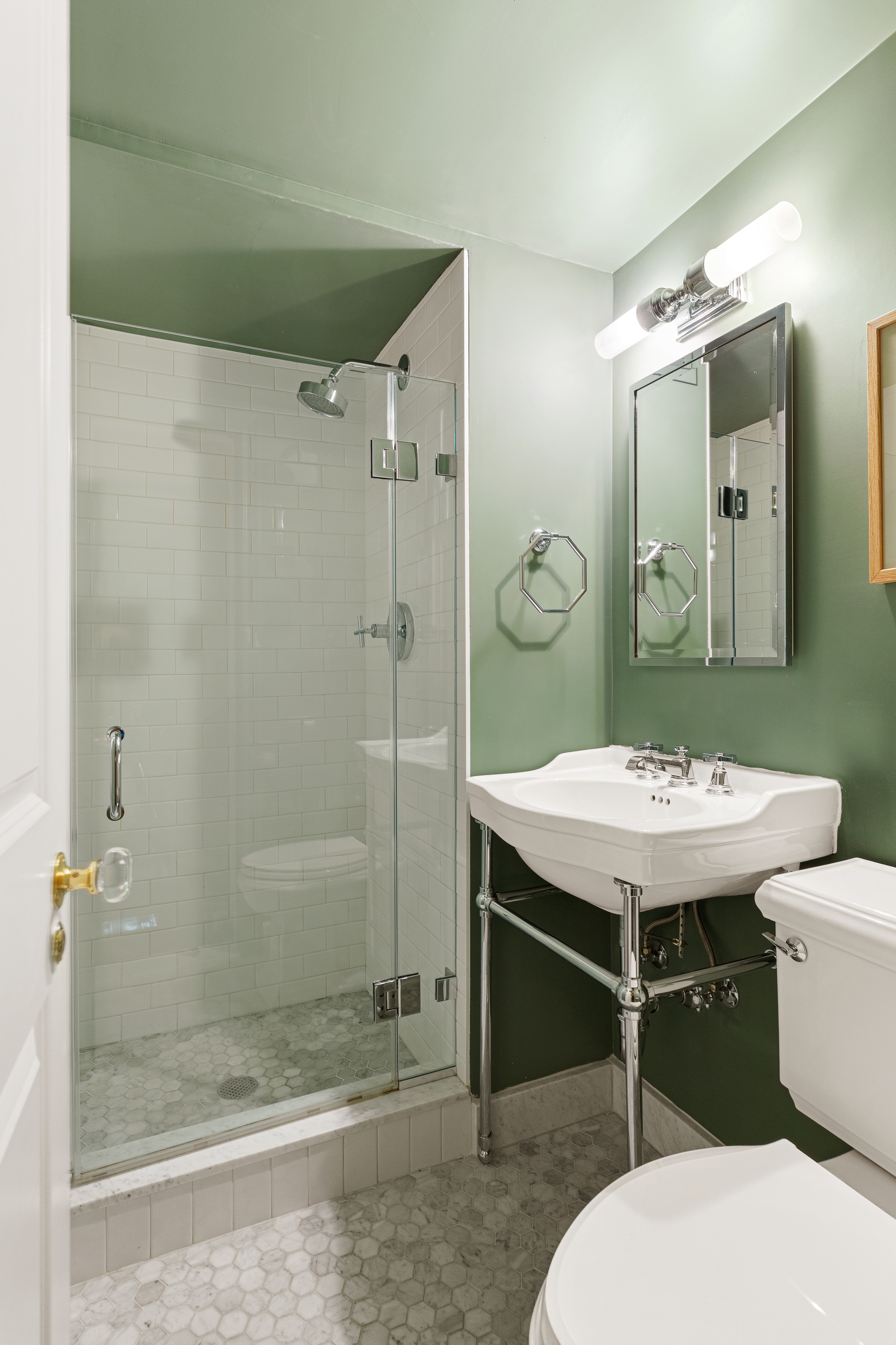 174 East 74th Street, Unit 3A Manhattan, NY 10021 - Photo 7 of 11 a bathroom with a sink a toilet and shower