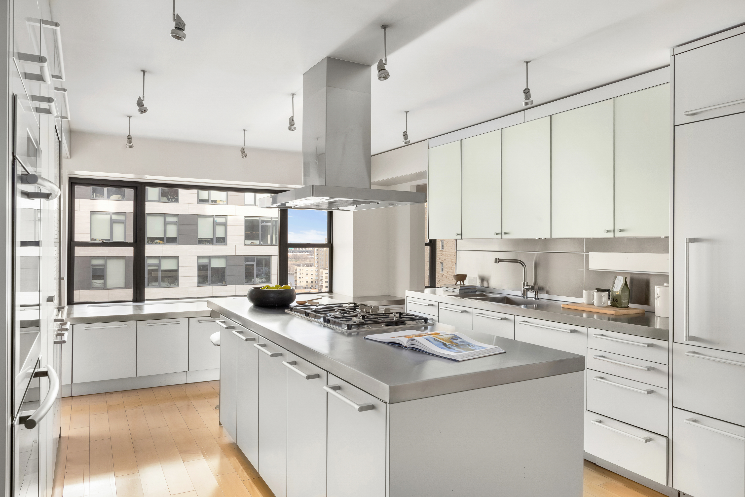 510 East 86th Street, Unit 17C Manhattan, NY 10028 - Photo 10 of 31 a kitchen with stainless steel appliances granite countertop a sink a stove and a refrigerator
