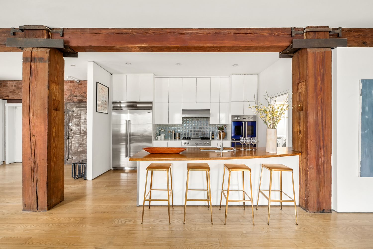 a kitchen with stainless steel appliances granite countertop a refrigerator and a stove top oven