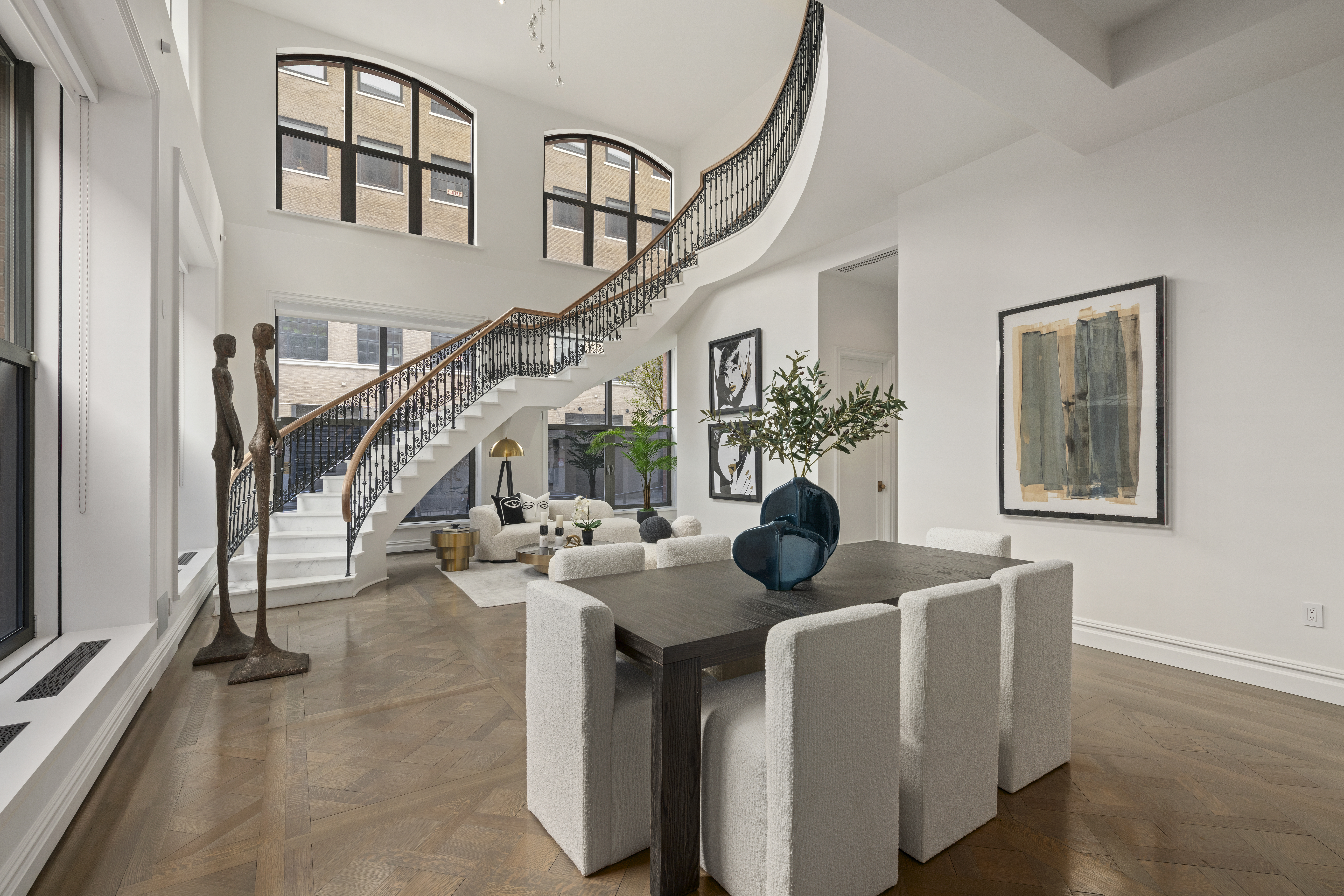415 Washington Street, Unit 1B Manhattan, NY 10013 - Photo 1 of 16 a living room with couches and a potted plant on a table
