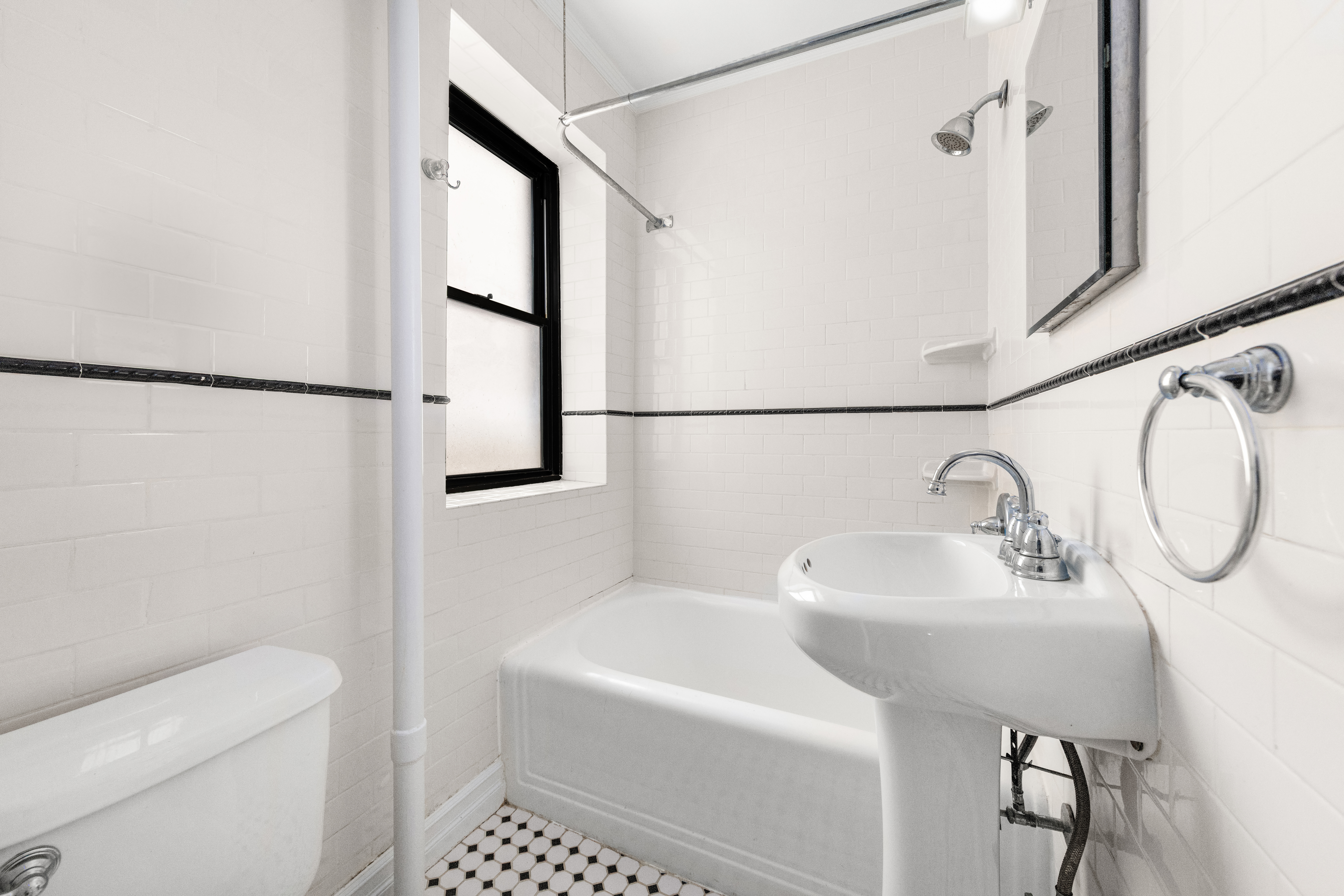 436 East 58th Street, Unit 1C Manhattan, NY 10022 - Photo 9 of 14 a bathroom with a sink toilet and a mirror