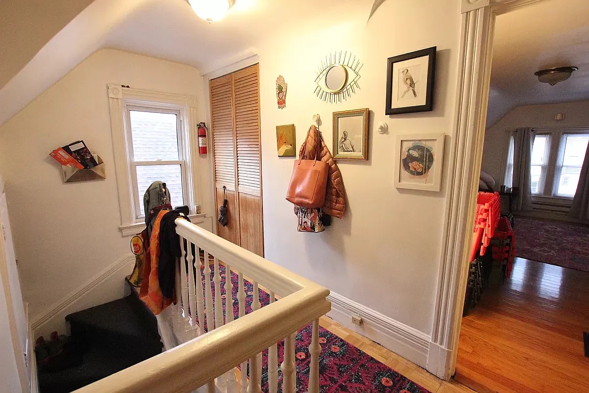 258 East 5th Street, Unit 4 Brooklyn, NY 11218 - Photo 1 of 5 a view of a hallway with wooden floor and stairs