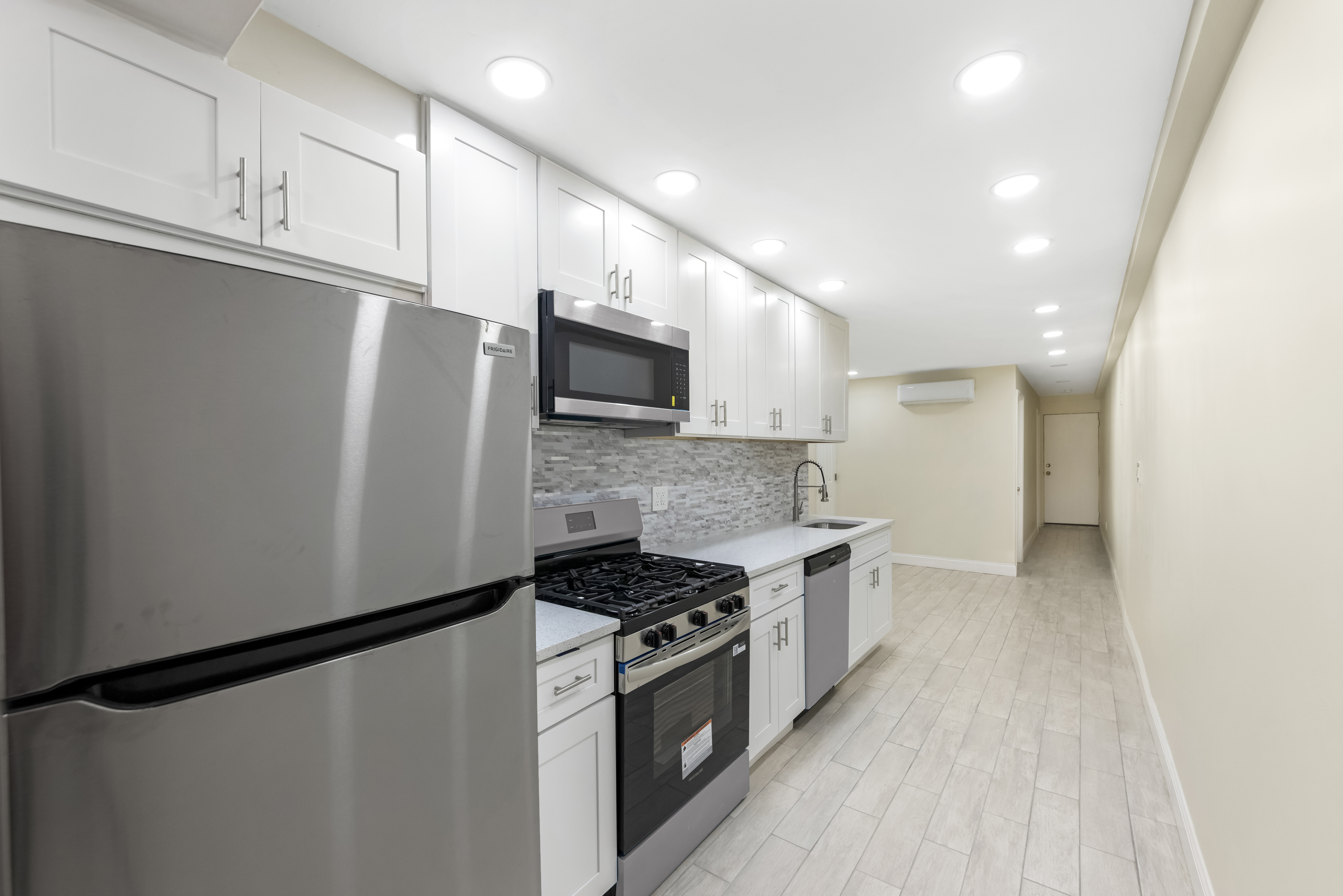 185 Oxford Street Brooklyn, NY 11235 - Photo 6 of 17 a kitchen with stainless steel appliances a refrigerator sink and microwave