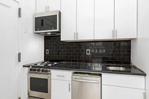 a kitchen with a stove and a microwave
