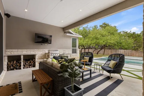 a living room with furniture a flat screen tv and a fireplace