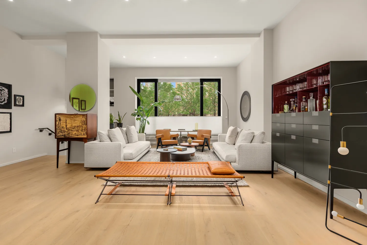 a living room with furniture a window and a flat screen tv
