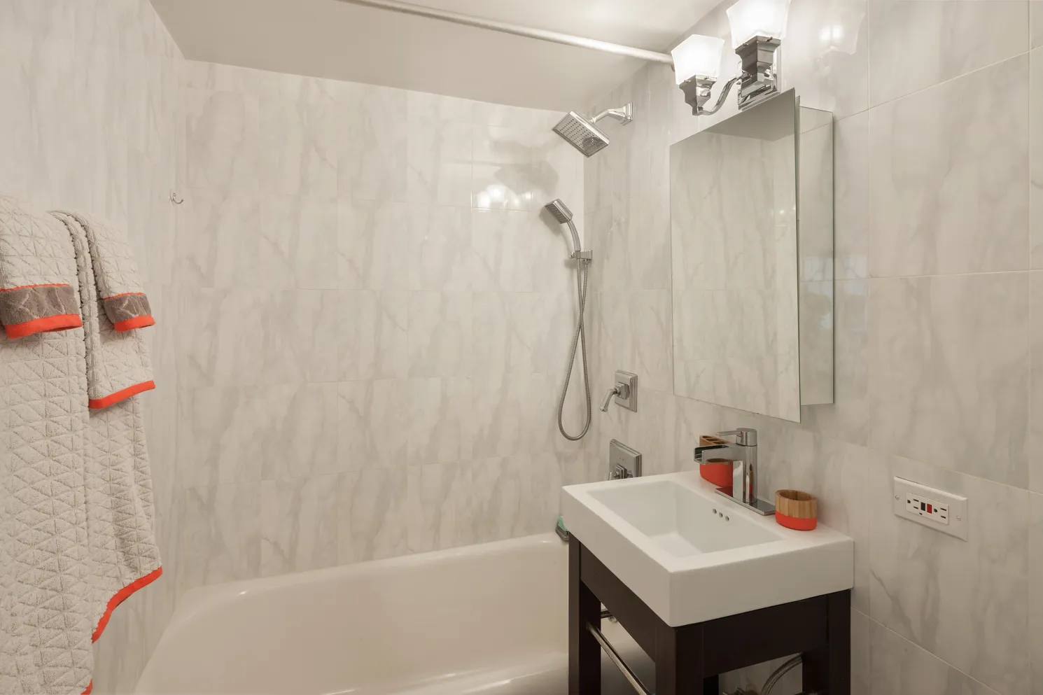 a bathroom with a sink a mirror and a shower