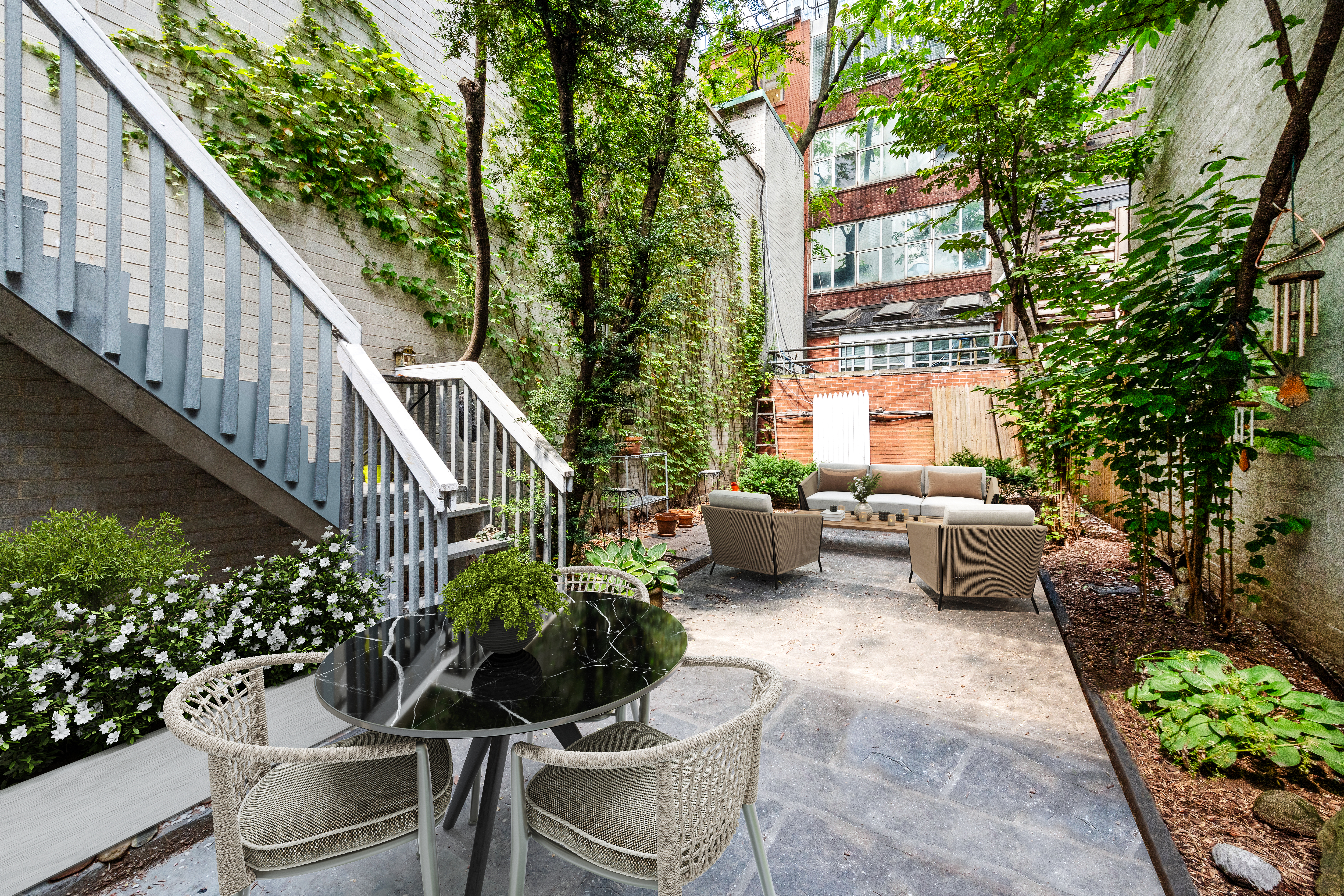 209 East 48th Street Manhattan, NY 10017 - Photo 3 of 13 a view of a patio with couches table and chairs and potted plants