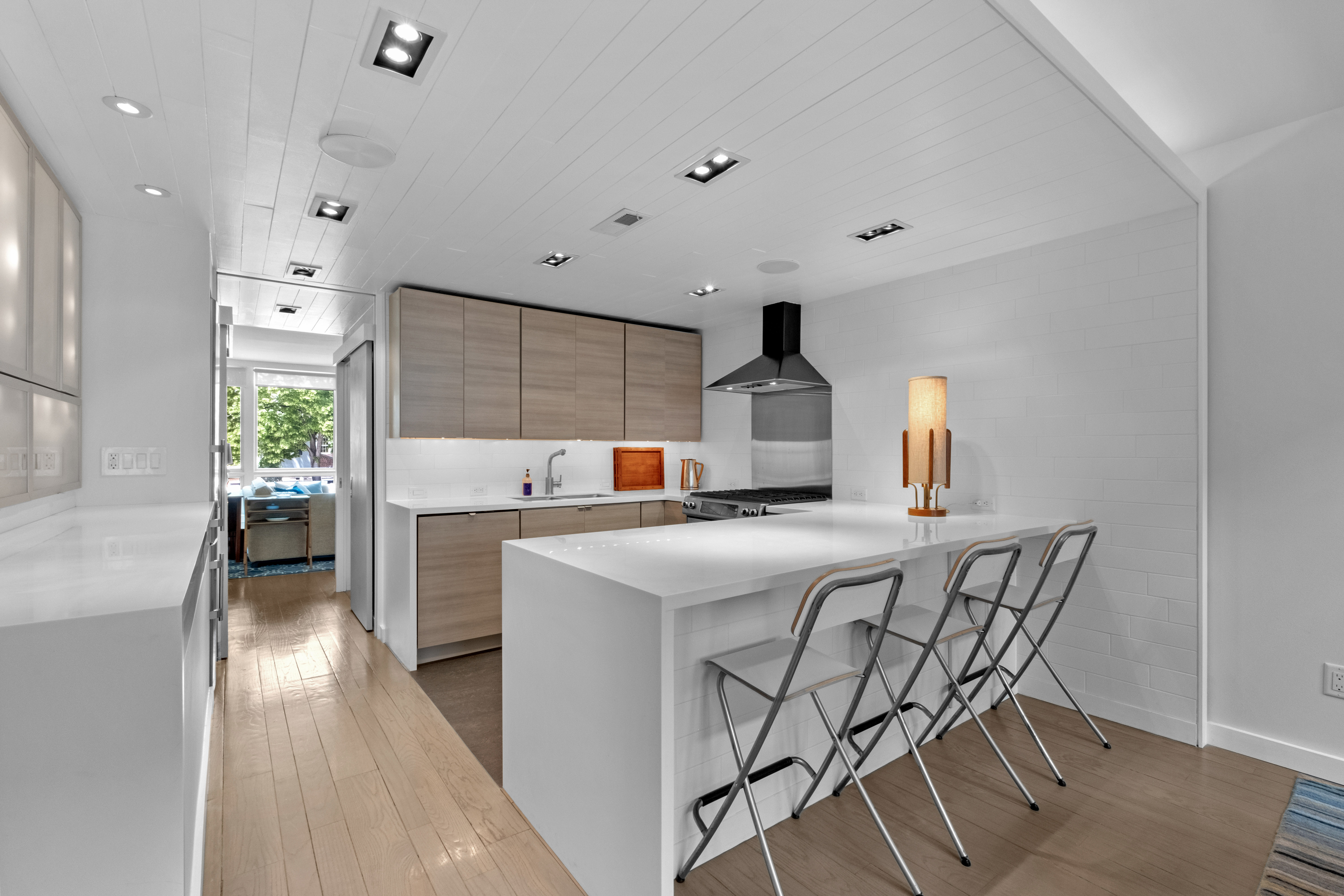 256 1/2 South 3rd Street Philadelphia, PA 19106 - Photo 17 of 73 a kitchen with stainless steel appliances a sink a stove a refrigerator cabinets and living room view