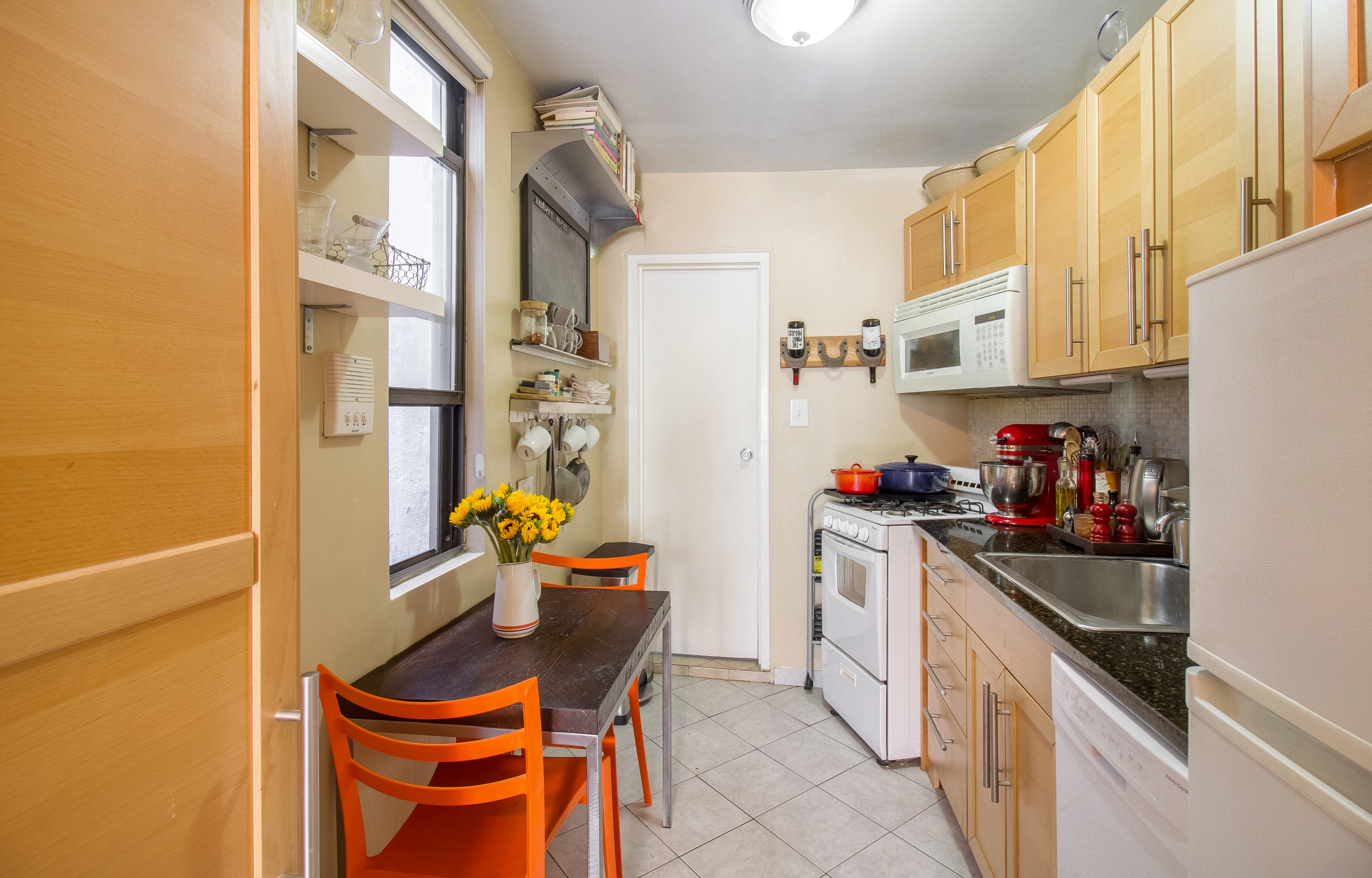 246 East 90th Street, Unit 5C Manhattan, NY 10128 - Photo 4 of 13 a kitchen with stainless steel appliances a sink a stove and a refrigerator