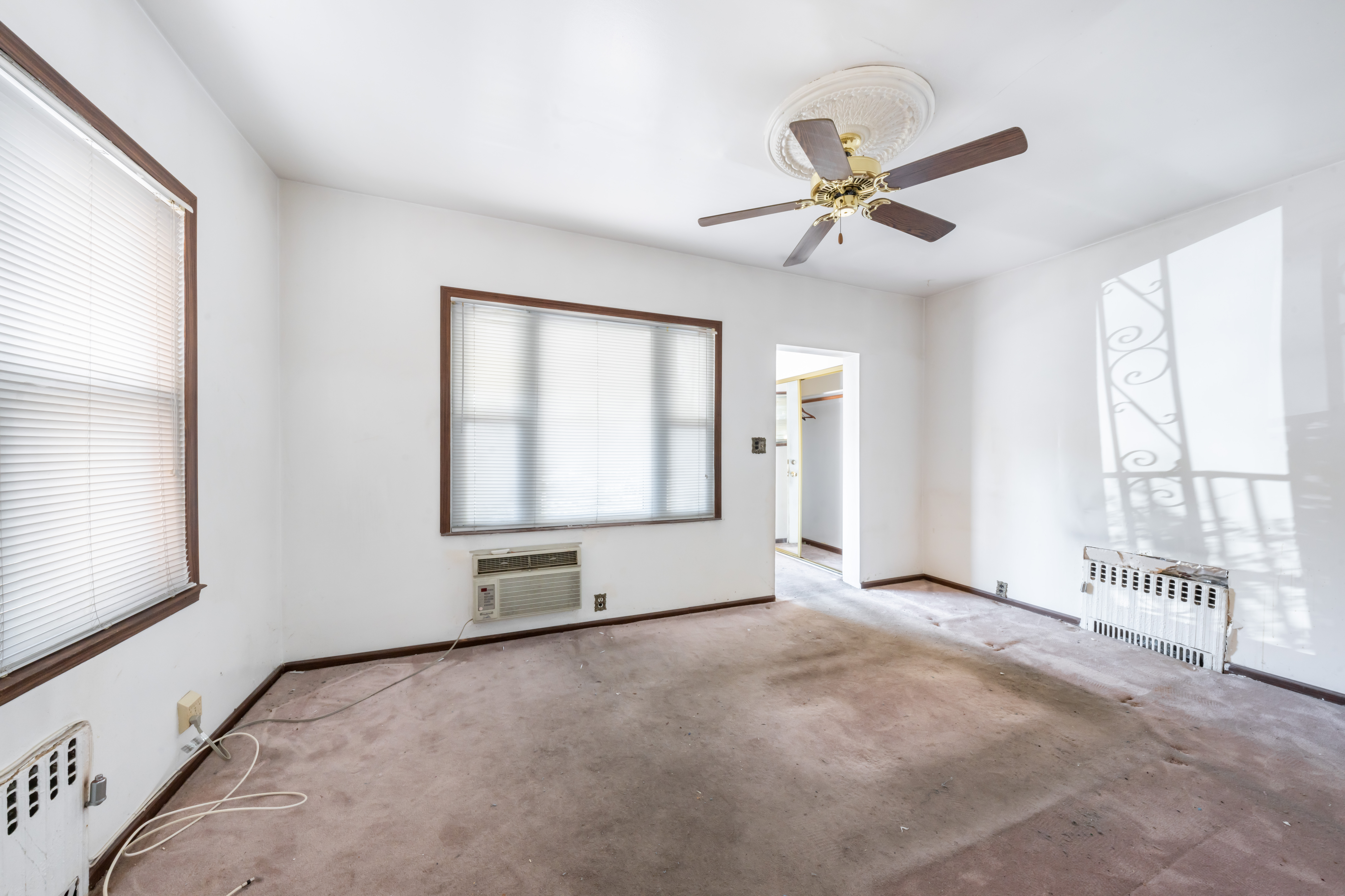 1085 Arnow Avenue Bronx, NY 10469 - Photo 3 of 16 an empty room with chandelier fan and windows