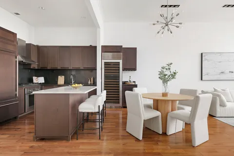 a kitchen with a table chairs and a refrigerator