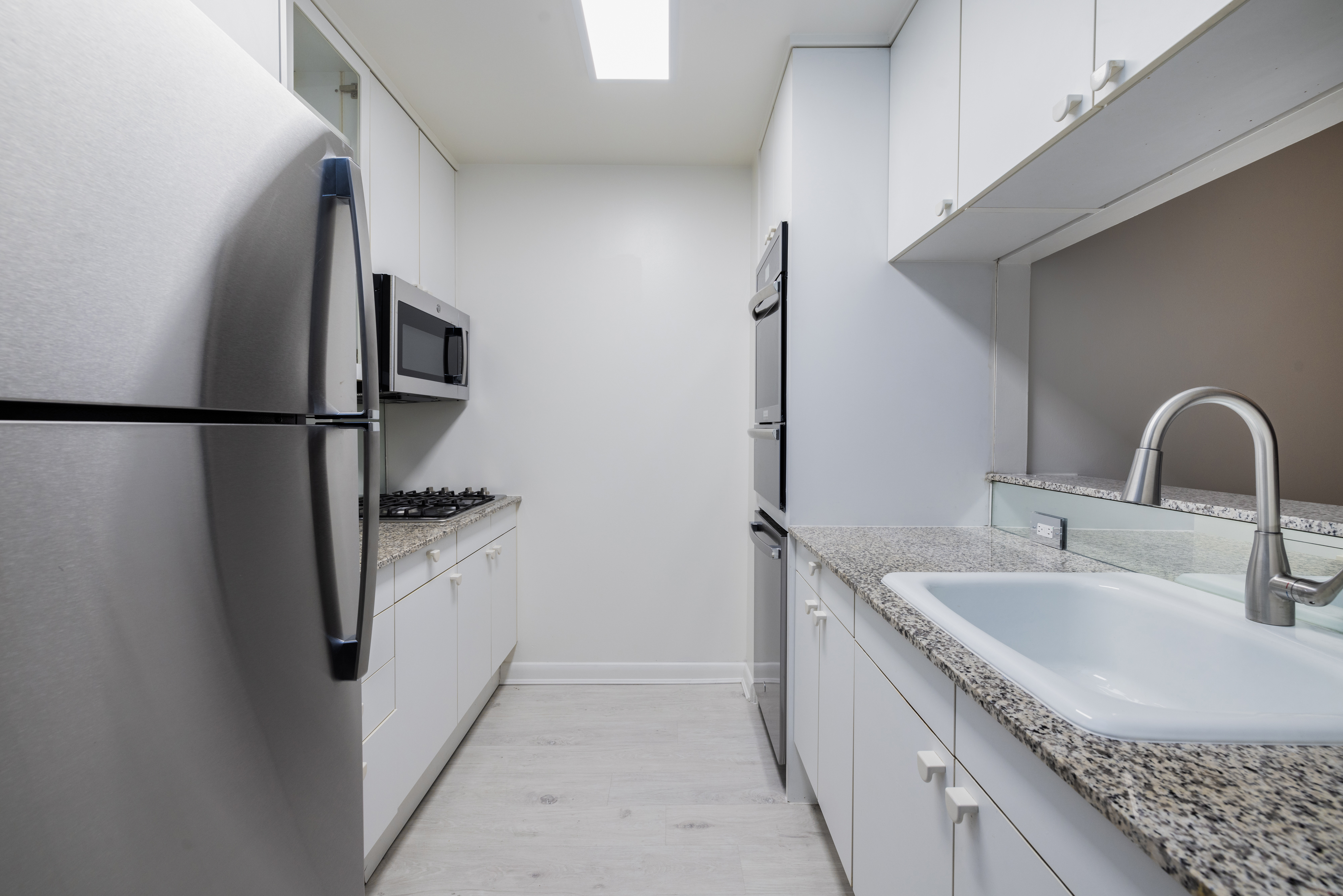 200 East 32nd Street, Unit 35C Manhattan, NY 10016 - Photo 13 of 26 a kitchen with a sink and refrigerator