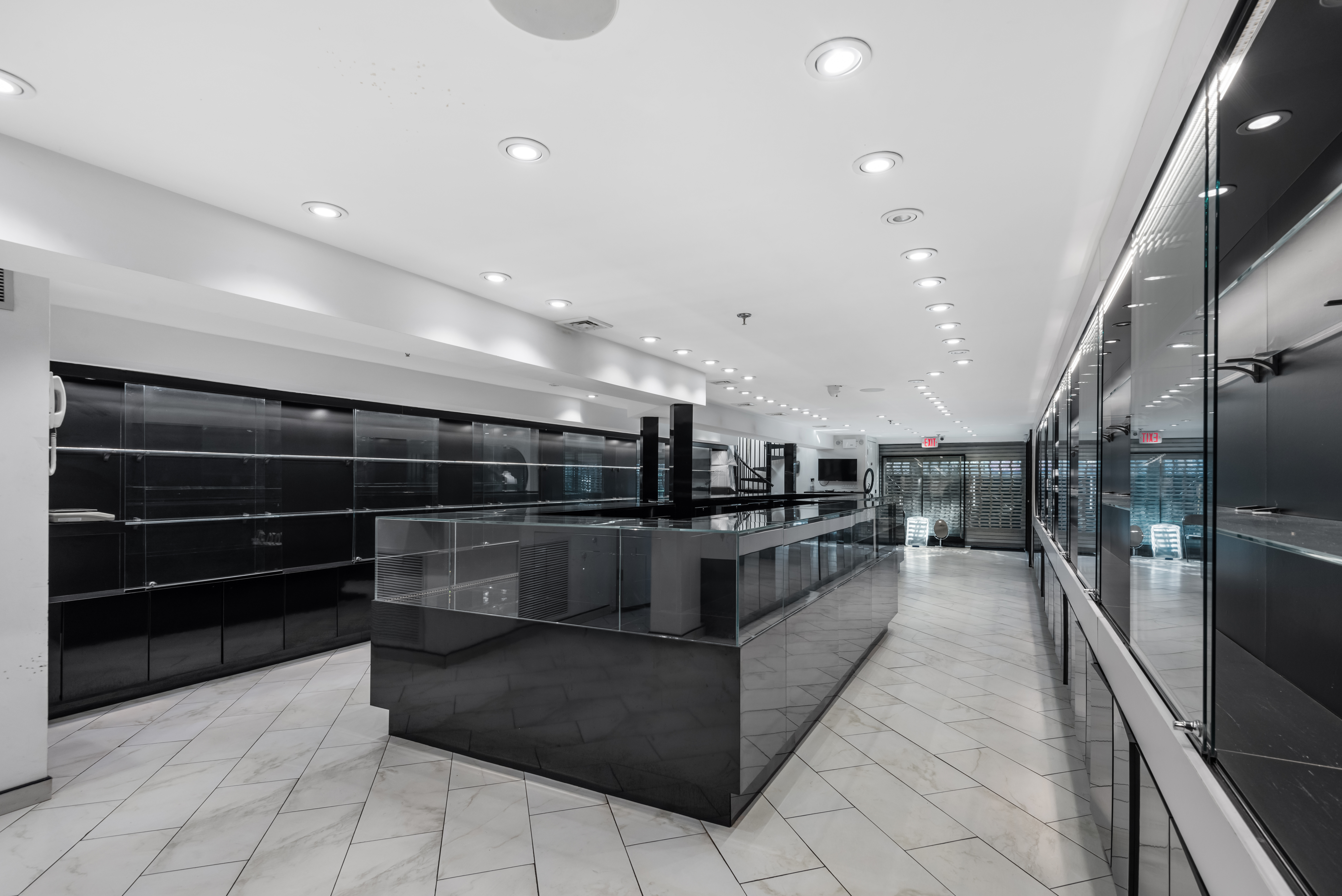37-14 74th Street Queens, NY 11372 - Photo 5 of 8 a living room with stainless steel appliances kitchen island granite countertop lots of counter space and cabinets
