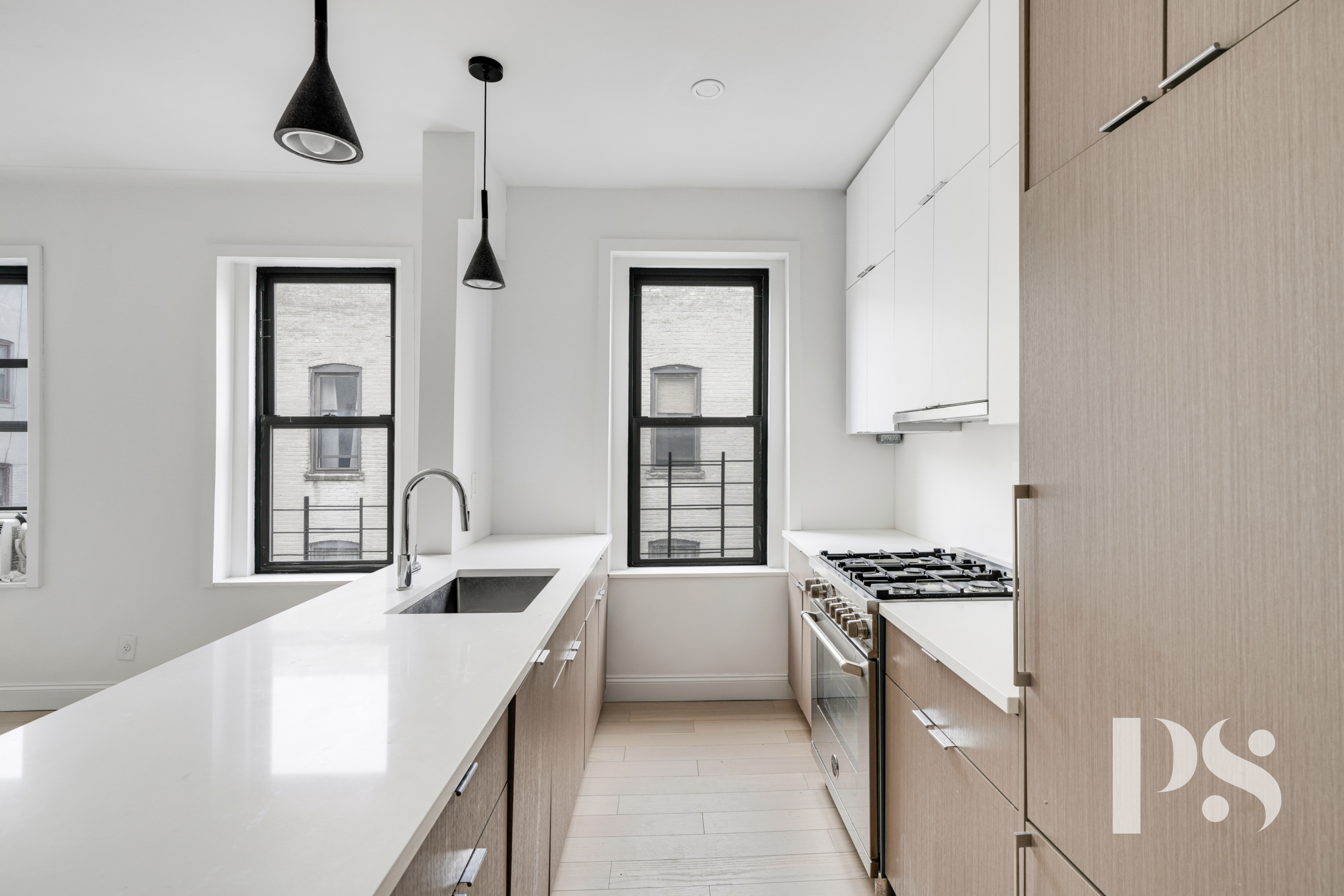 24-51 38th Street, Unit D1 Queens, NY 11103 - Photo 3 of 7 a kitchen with sink cabinets and stove