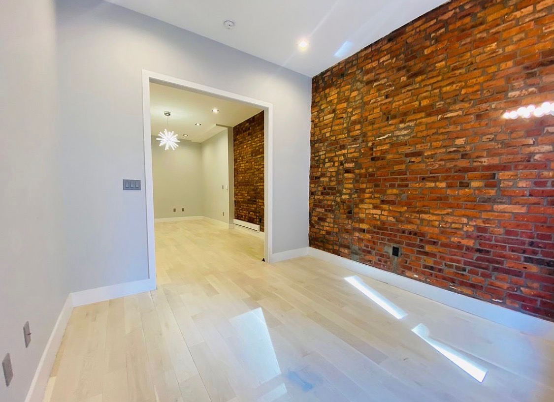 133 East 35th Street, Unit 3 Manhattan, NY 10016 - Photo 10 of 16 a view of hallway with wooden floor and brick wall