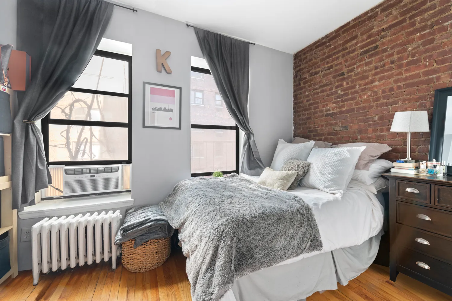 a bed sitting in a bedroom next to a window