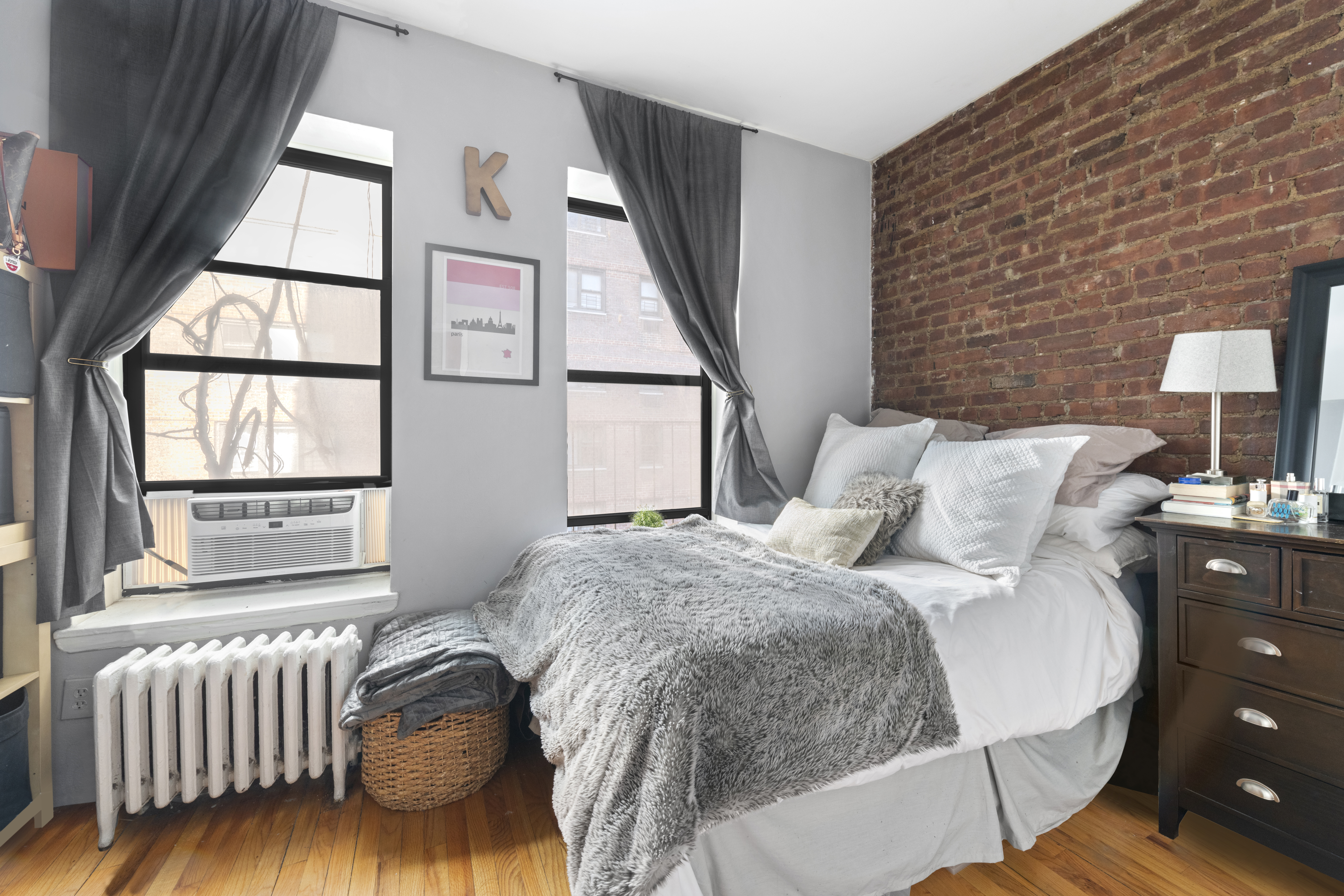 a bed sitting in a bedroom next to a window