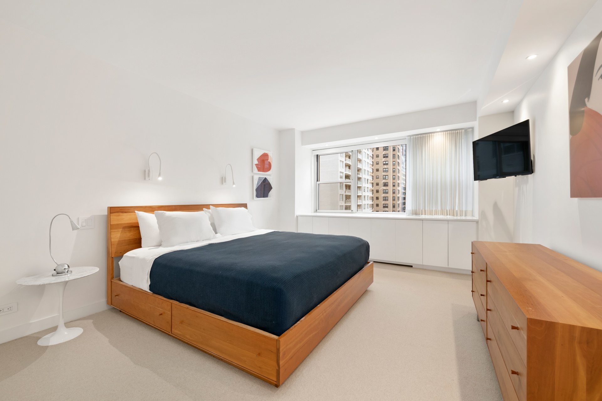 150 East 69th Street, Unit 7K Manhattan, NY 10021 - Photo 7 of 22 a bedroom with a bed and a flat screen tv