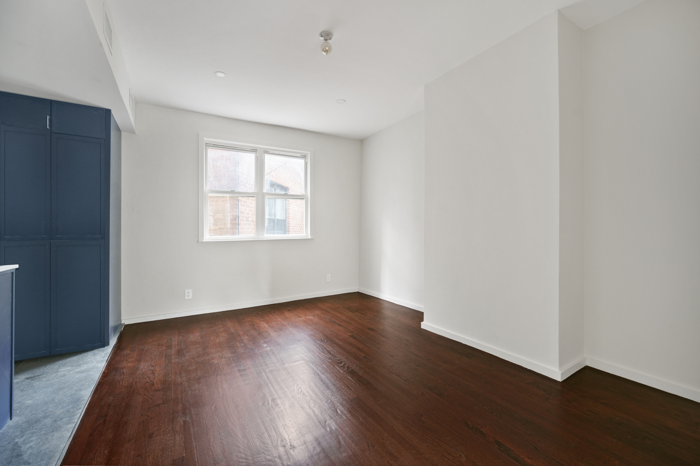441 Metropolitan Avenue, Unit 1 Brooklyn, NY 11211 - Photo 2 of 11 an empty room with wooden floor and windows