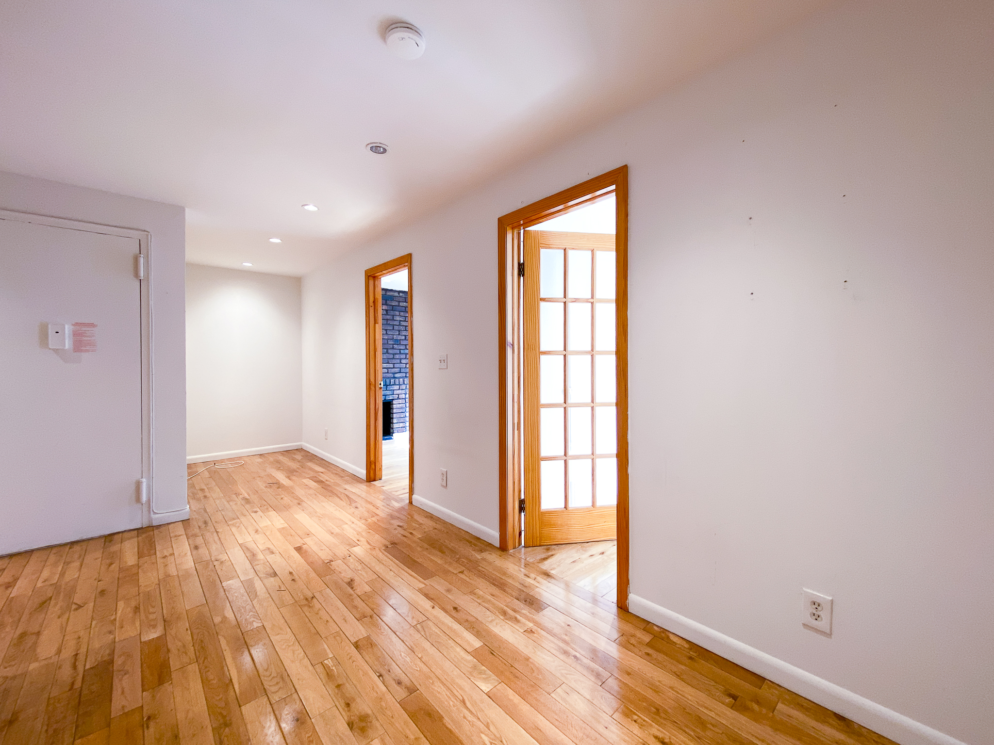 157 East 3rd Street, Unit 2B Manhattan, NY 10009 - Photo 8 of 18 a view of empty room with wooden floor and fan