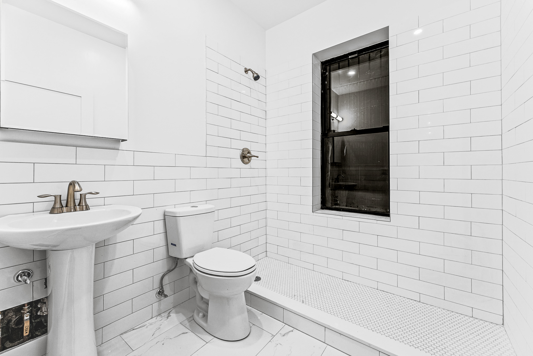 280 Suydam Street, Unit 2R Brooklyn, NY 11237 - Photo 6 of 6 a bathroom with a toilet sink and mirror