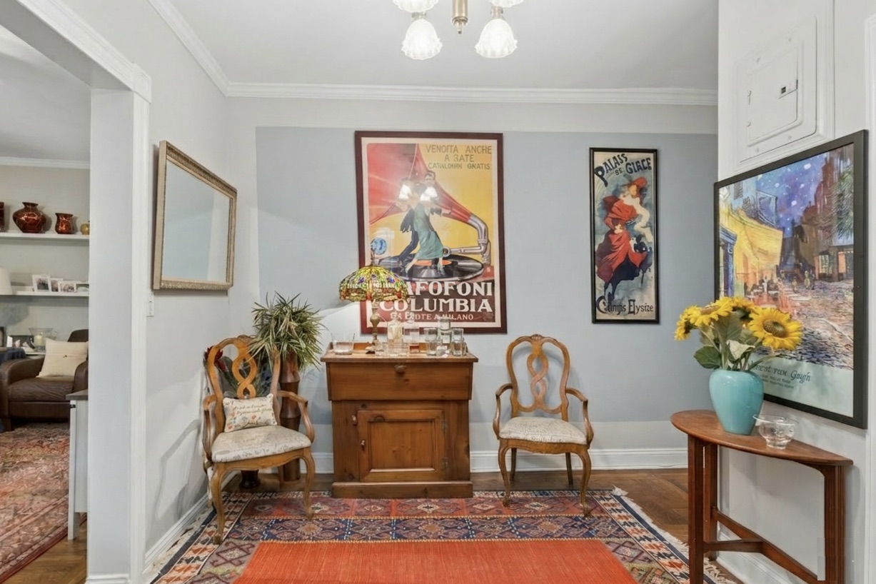 a living room with furniture and a potted plant