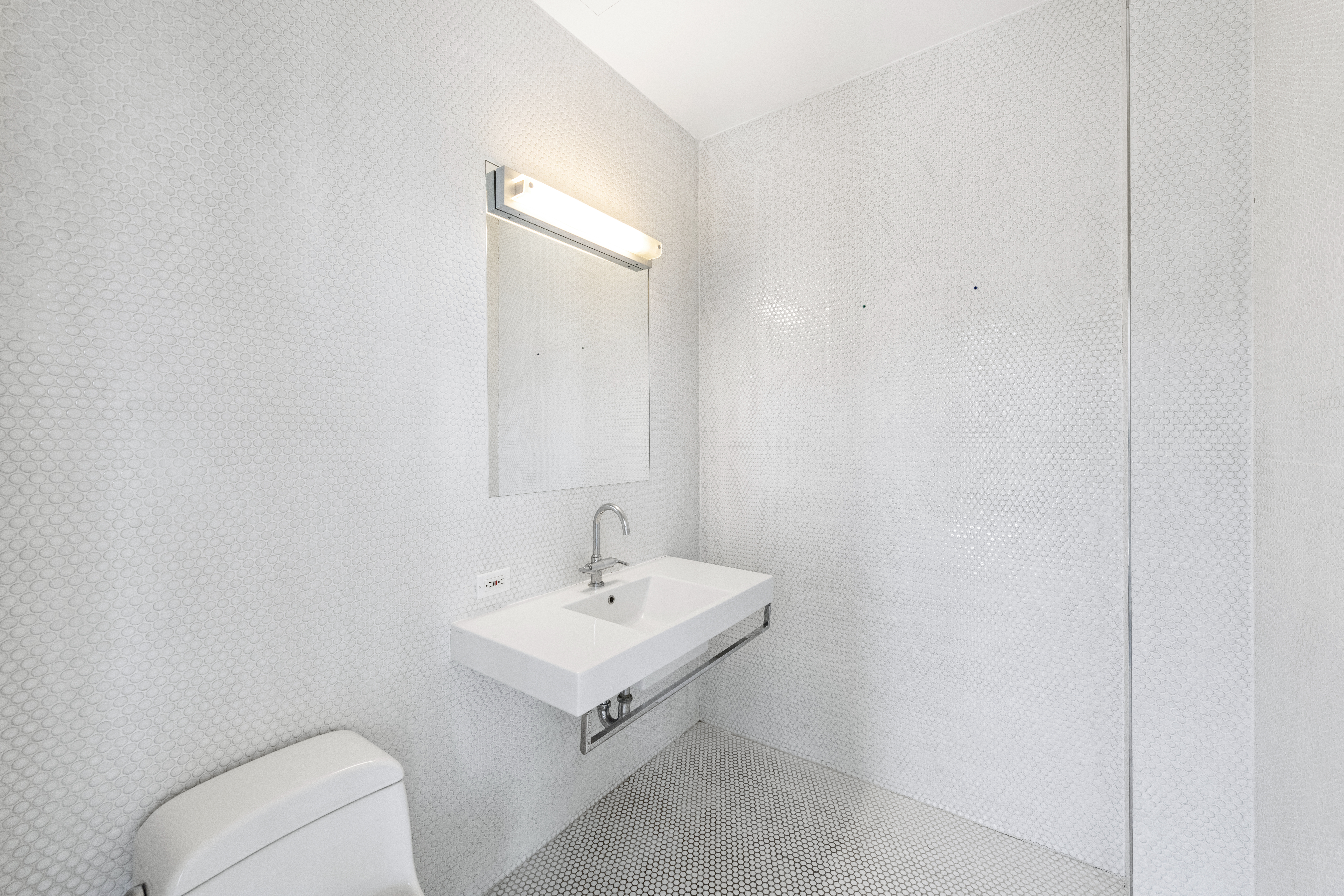 475 Greenwich Street, Unit PHN Manhattan, NY 10013 - Photo 19 of 28 a bathroom with a toilet a sink and mirror