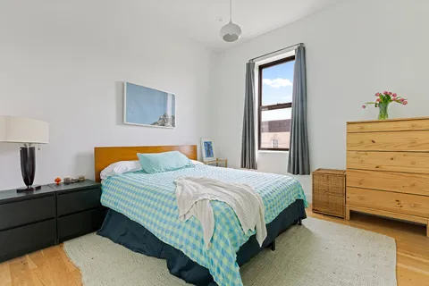 a bedroom with a bed and a window