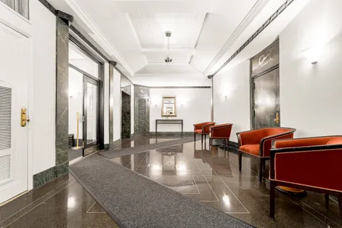 a lobby with furniture and rug