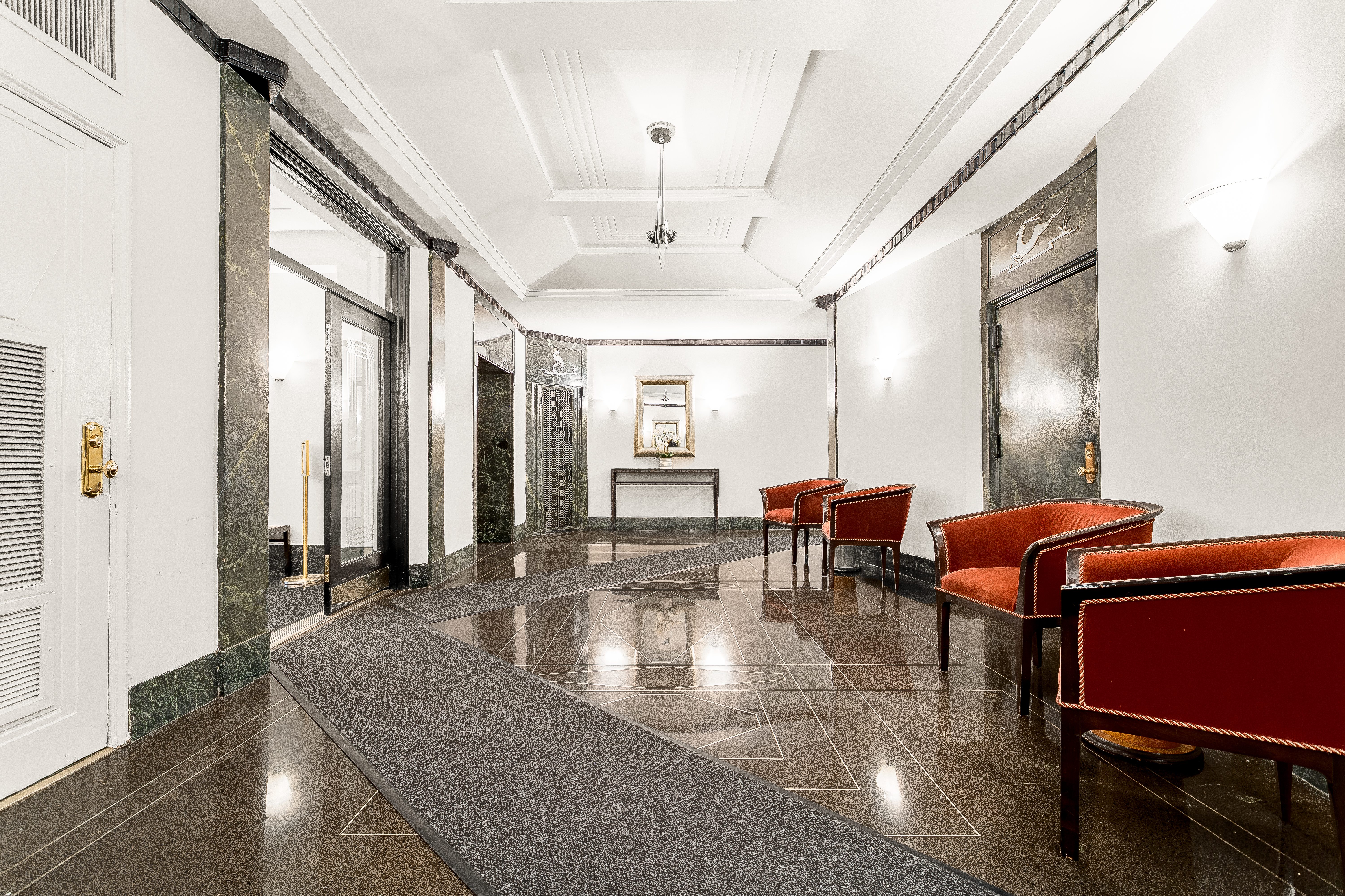 a lobby with furniture and rug