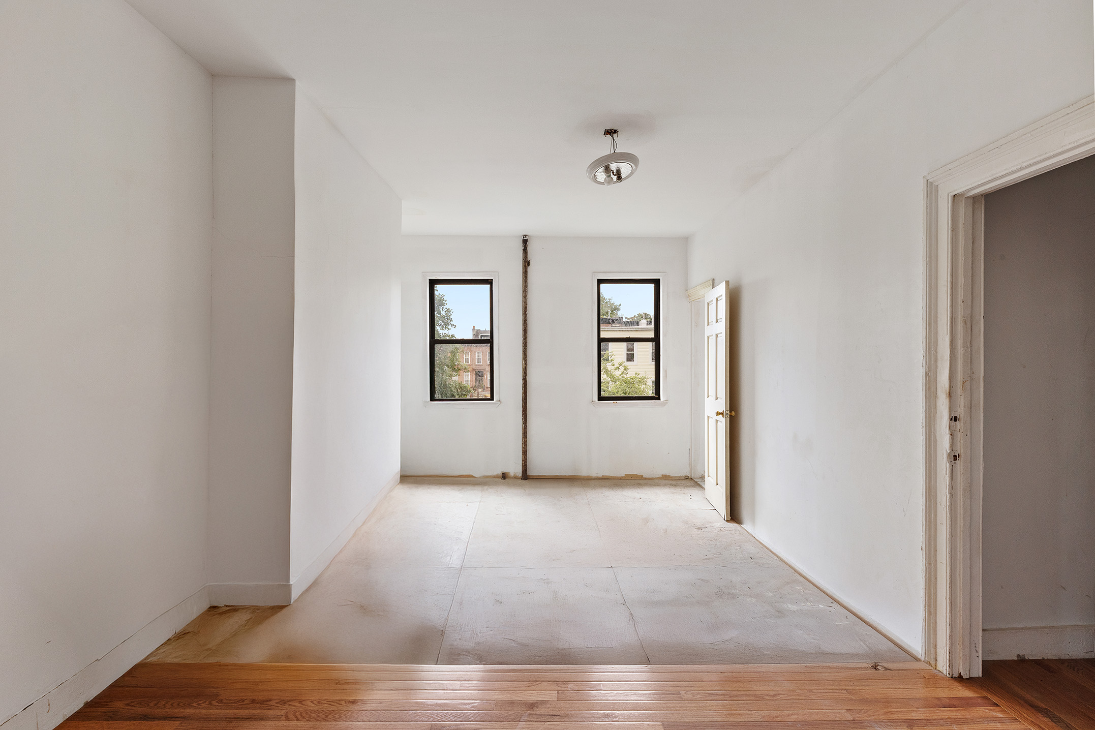 738 Lafayette Avenue Brooklyn, NY 11221 - Photo 9 of 12 an empty room with wooden floor and windows