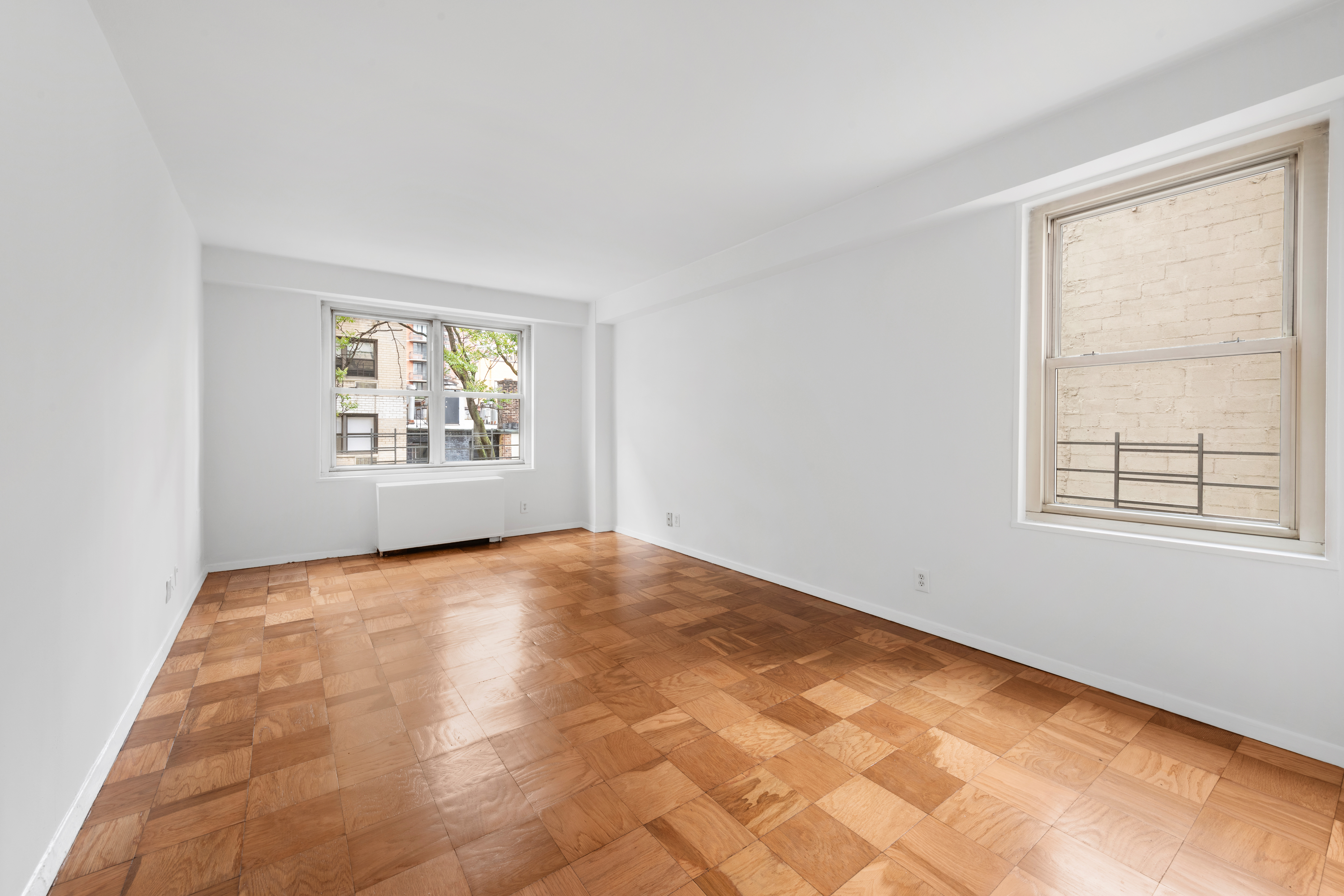 370 East 76th Street, Unit C607 Manhattan, NY 10021 - Photo 7 of 12 an empty room with windows