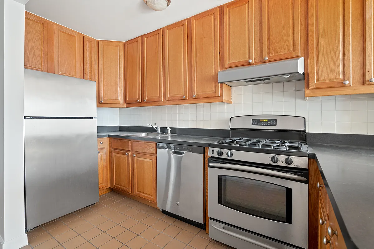 325 3rd Street, Unit 2B Brooklyn, NY 11215 - Photo 4 of 9 a kitchen with granite countertop cabinets stainless steel appliances and wooden cabinets
