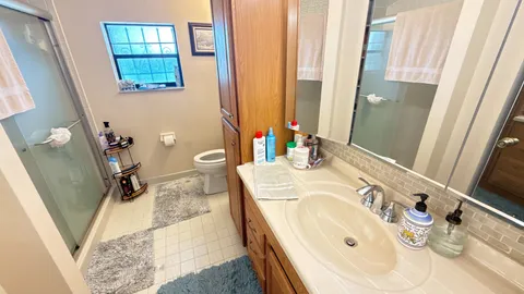a bathroom with a tub sink and mirror