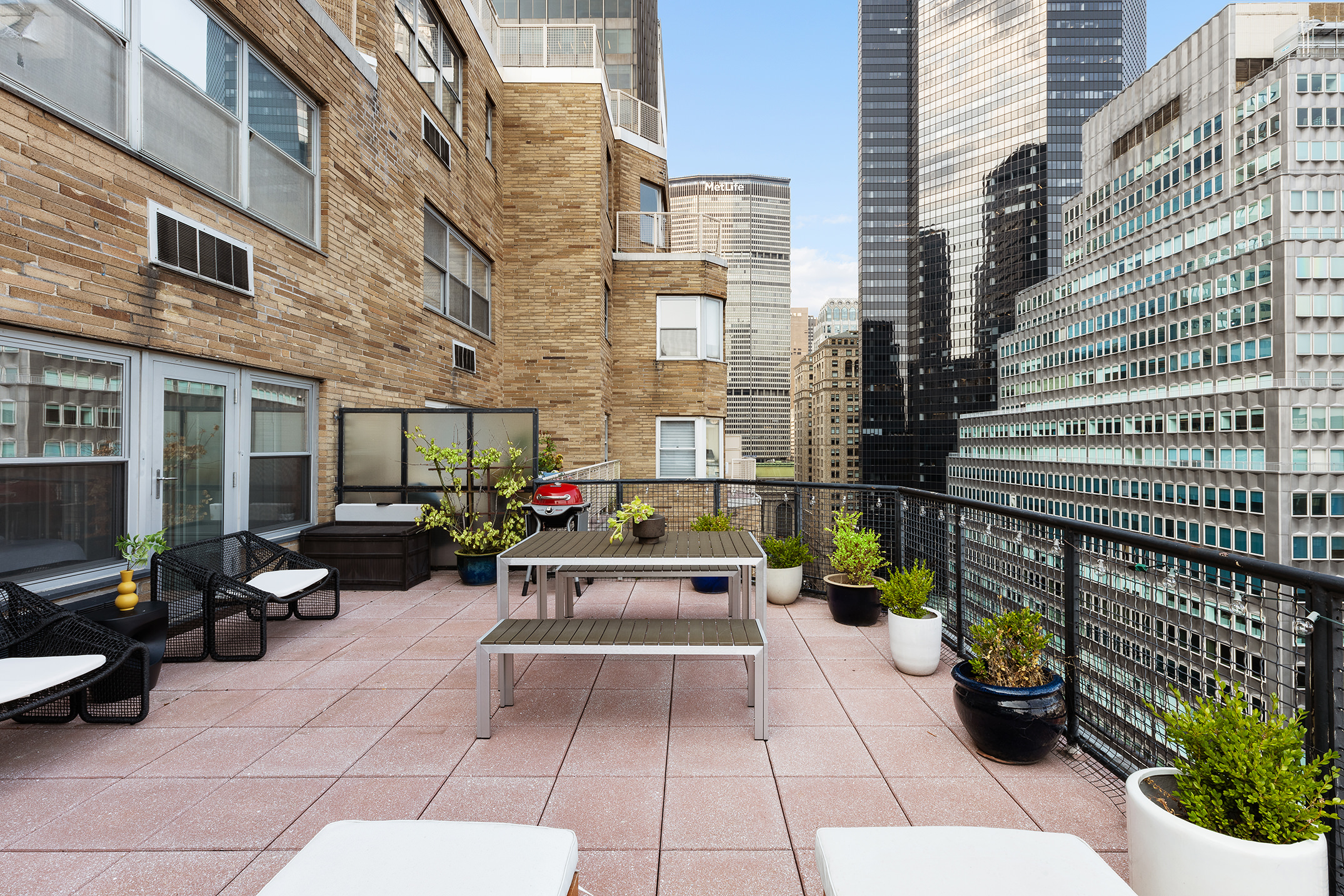80 Park Avenue, Unit 19N Manhattan, NY 10016 - Photo 4 of 20 a view of a patio with chairs and potted plants