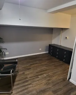 a view of bedroom and bedroom with wooden floor