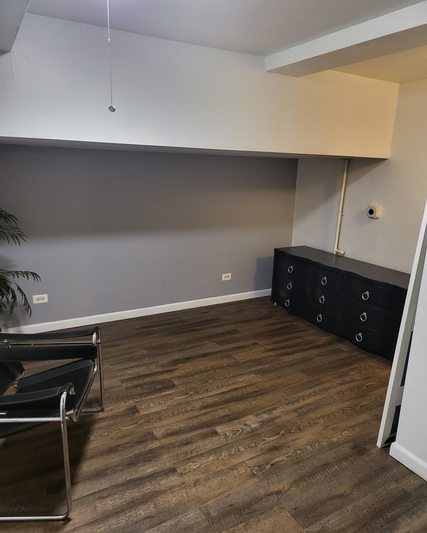 6337 Roosevelt Road, Unit 105 Berwyn, IL 60402 - Photo 6 of 21 a room with a closet and wooden floor