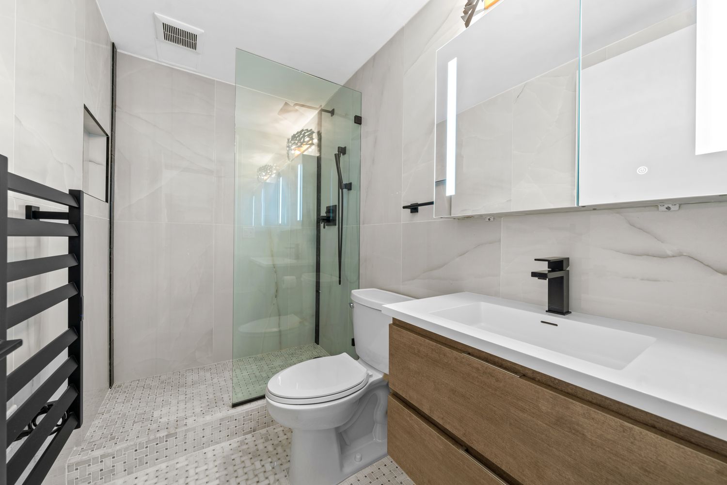 201 West 74th Street, Unit 8G Manhattan, NY 10023 - Photo 9 of 14 a bathroom with a sink a toilet and shower