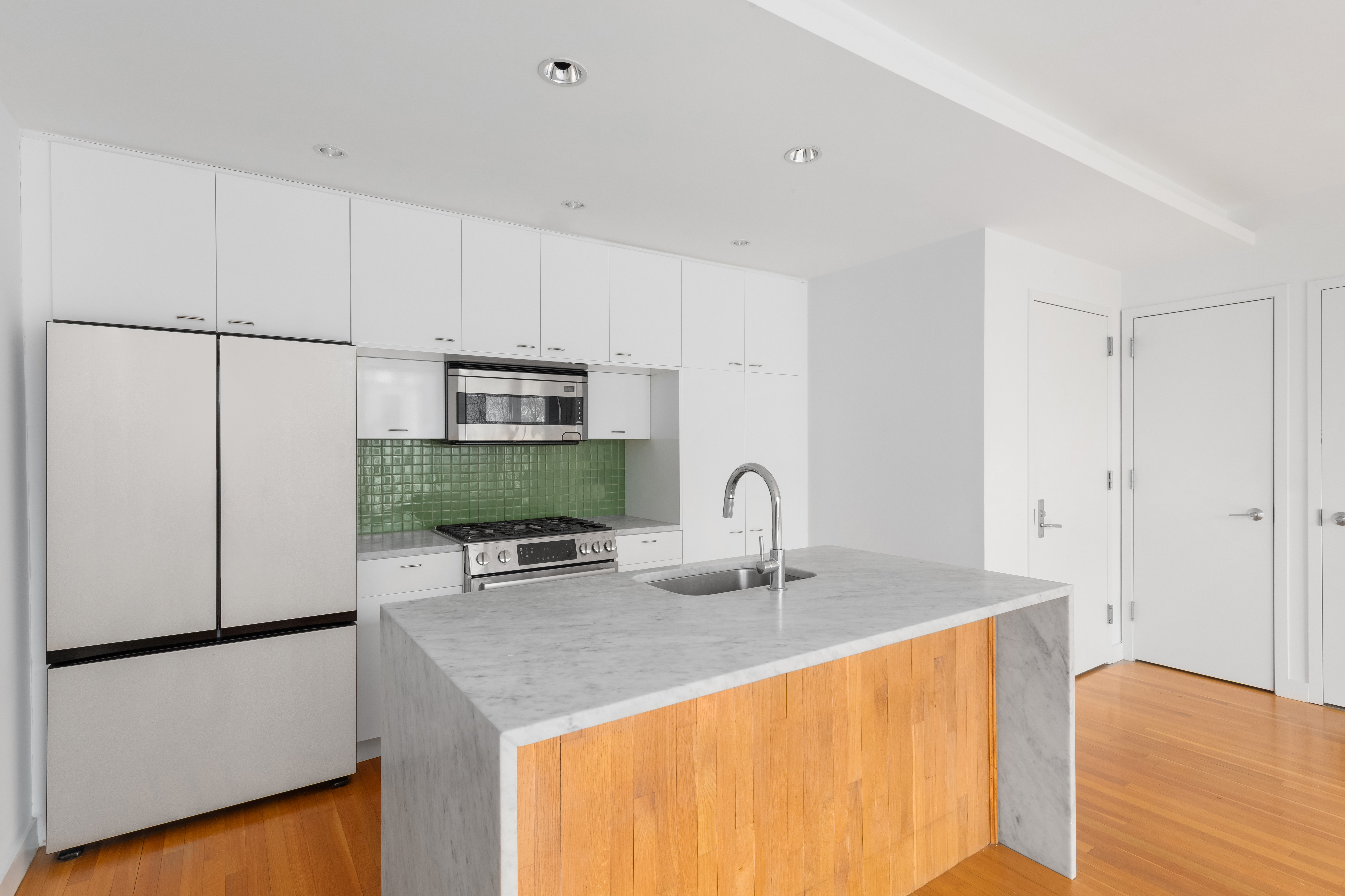 232 7th Street, Unit 3B Brooklyn, NY 11215 - Photo 5 of 7 a kitchen with stainless steel appliances granite countertop a sink refrigerator and cabinets