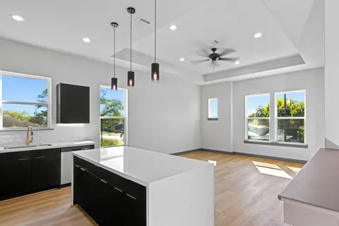 a kitchen with kitchen island a sink stainless steel appliances and cabinets