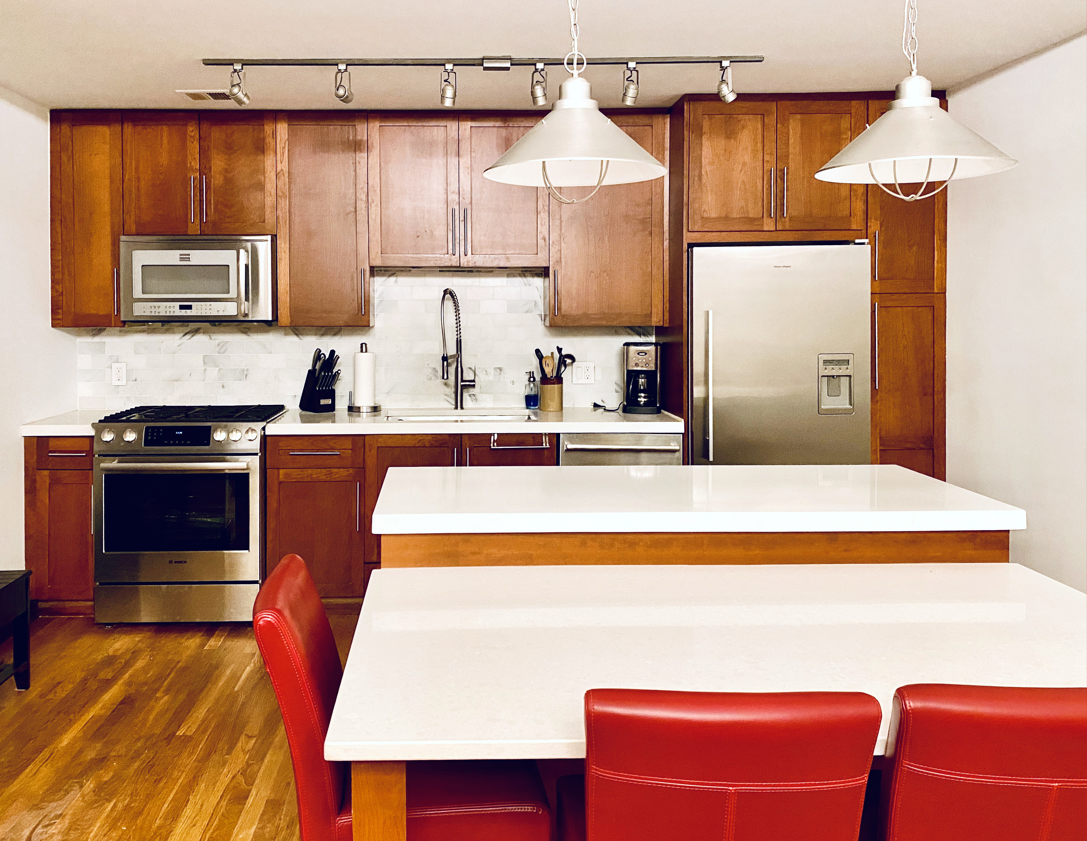 60 Court Street, Unit 2K Brooklyn, NY 11201 - Photo 2 of 6 a room with stainless steel appliances wooden floor and table
