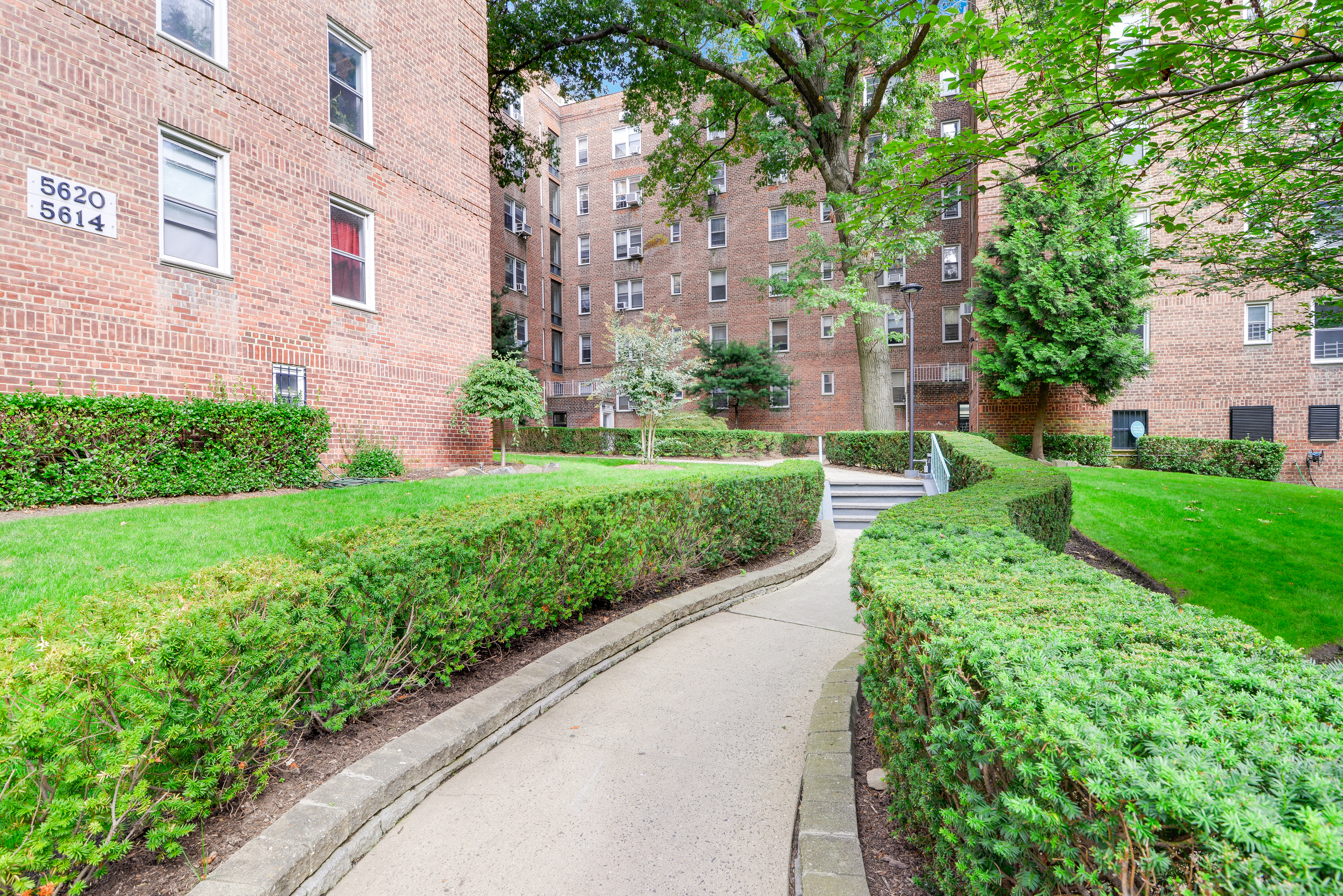 5614 Netherland Avenue, Unit 4E Bronx, NY 10471 - Photo 6 of 8 a view of a building with a yard